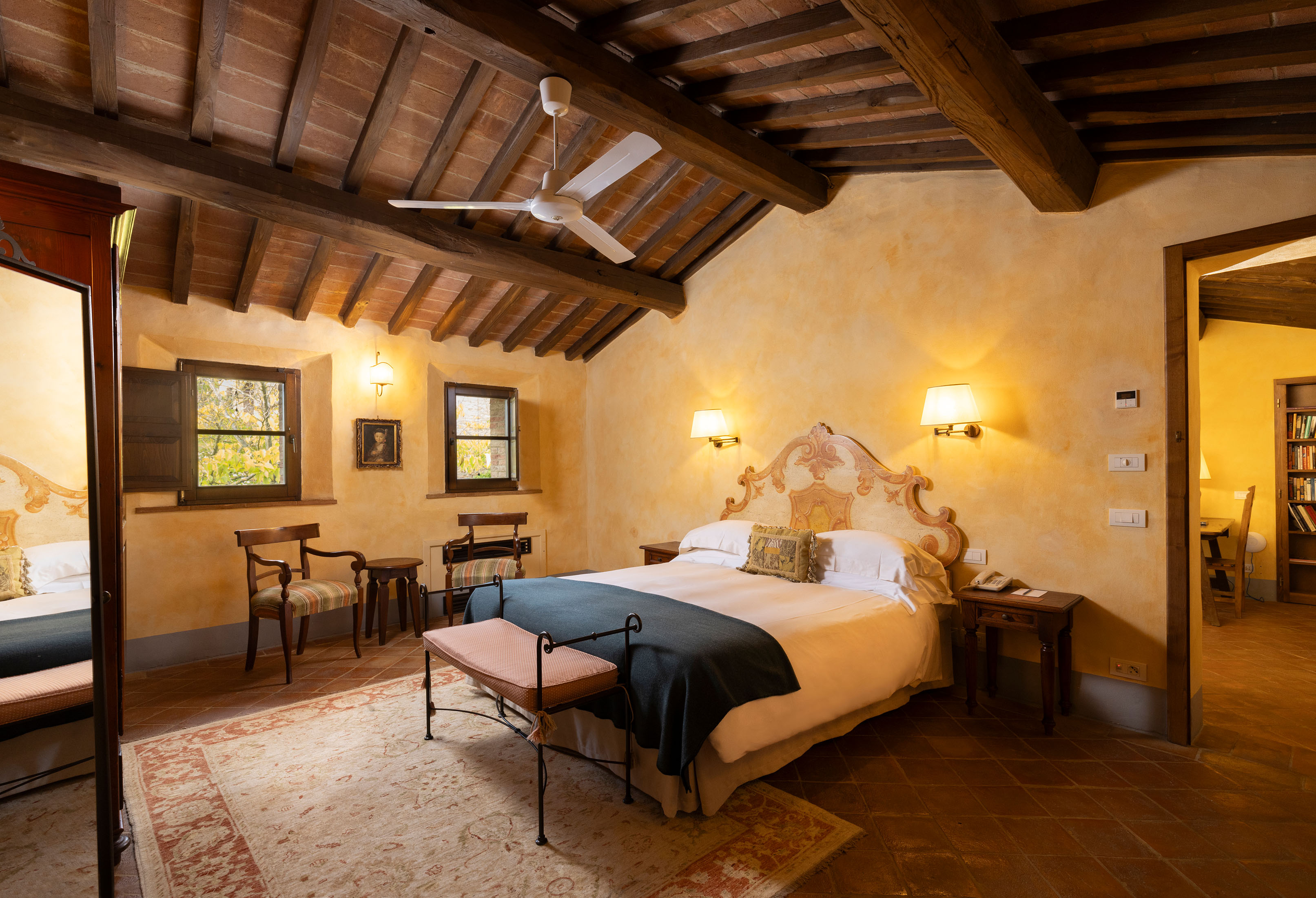 a bedroom with a bed and desk in a room