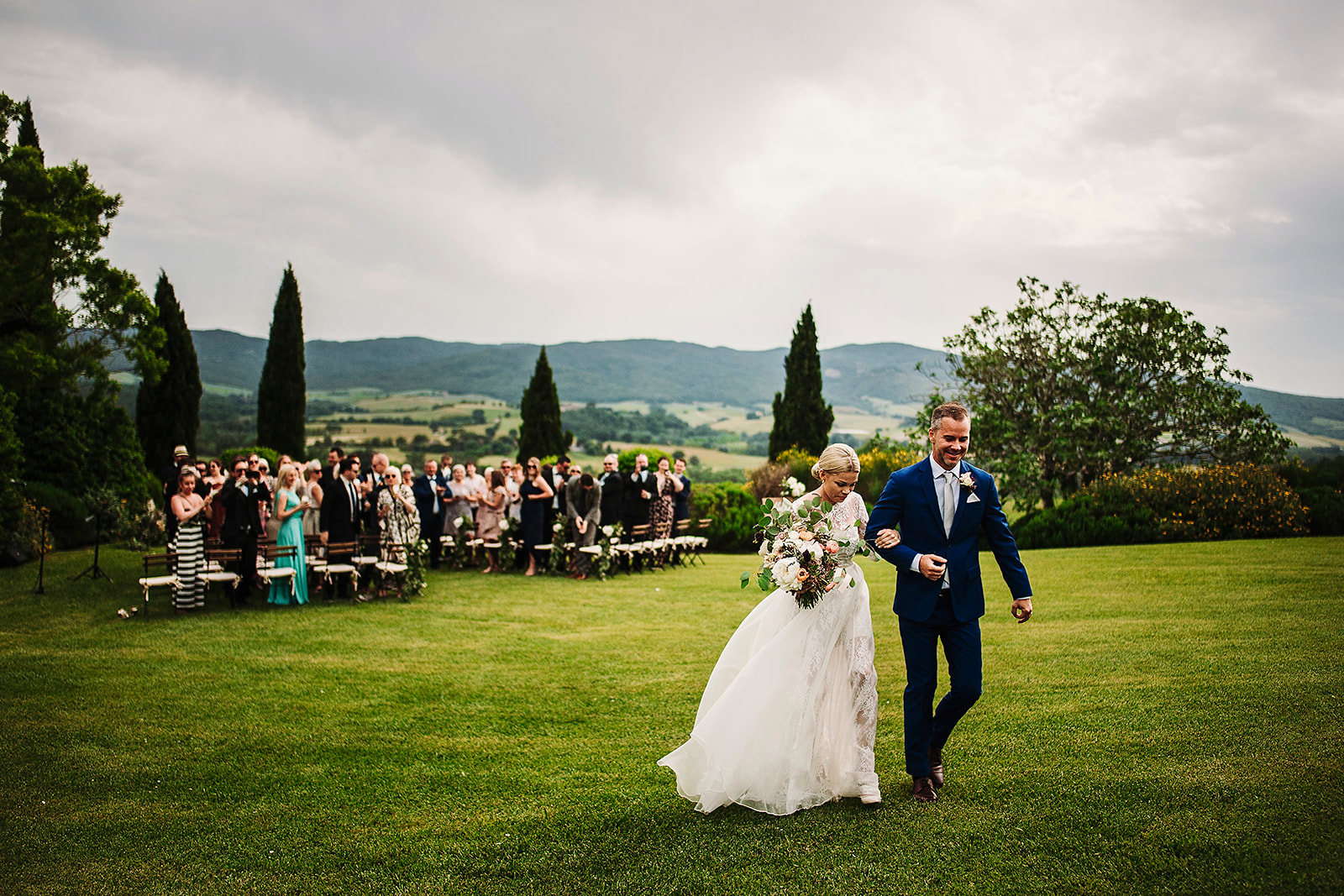 a group of people standing on top of a grass covered field