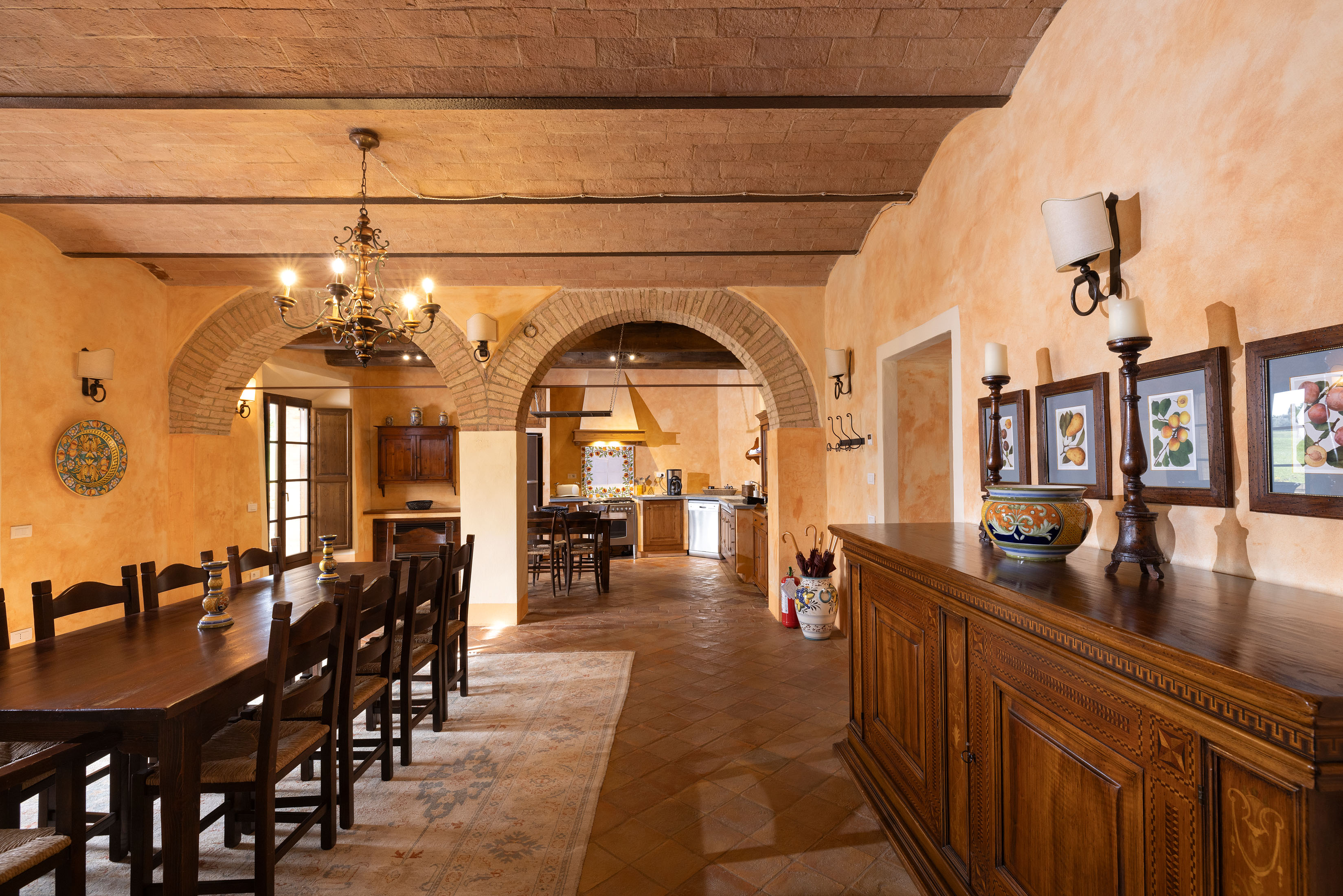a kitchen with wooden cabinets and a dining room table