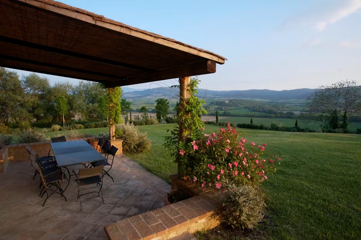 a house with bushes in front of a brick building
