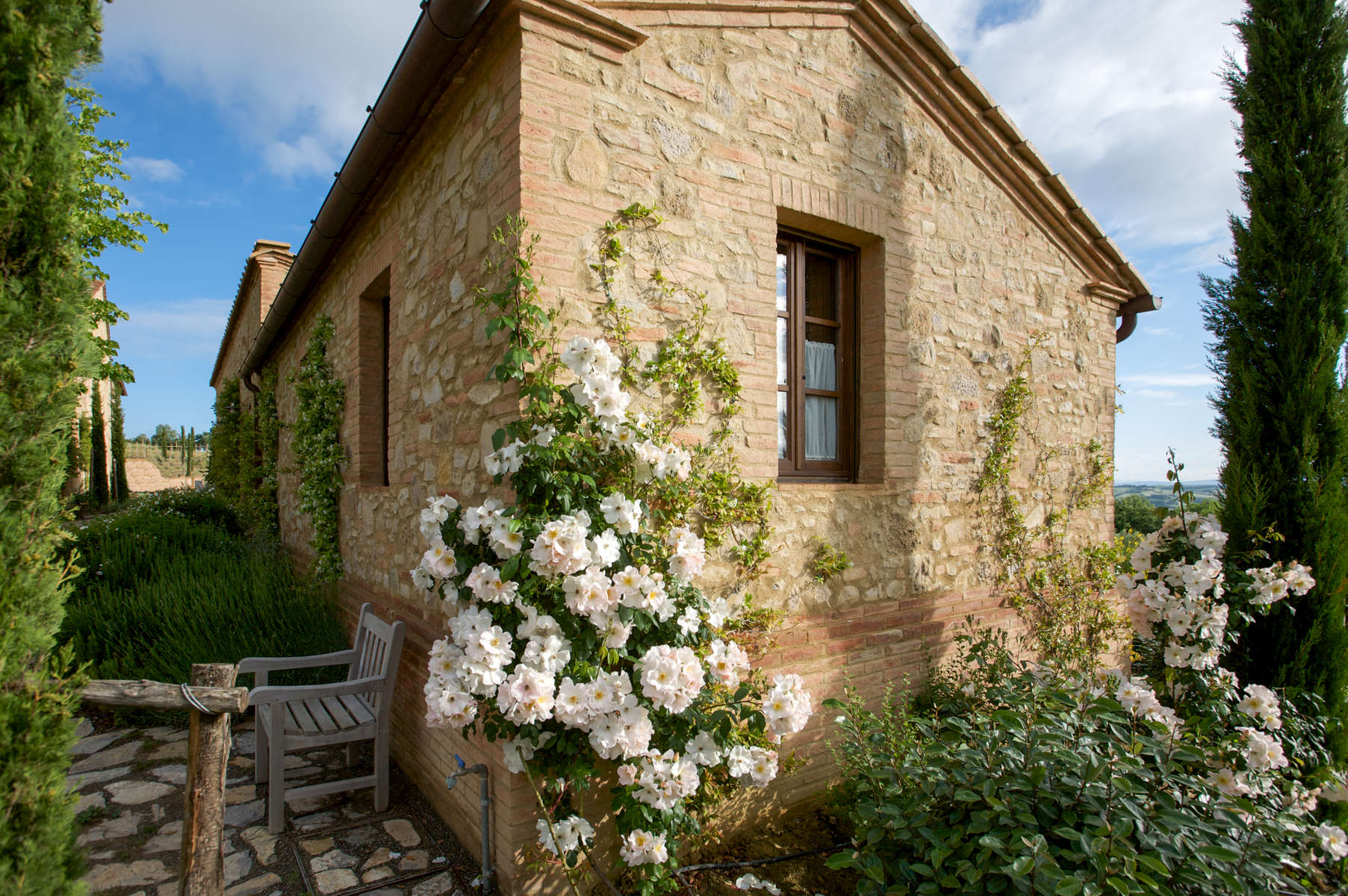 a large brick building with a clock on the side of a house