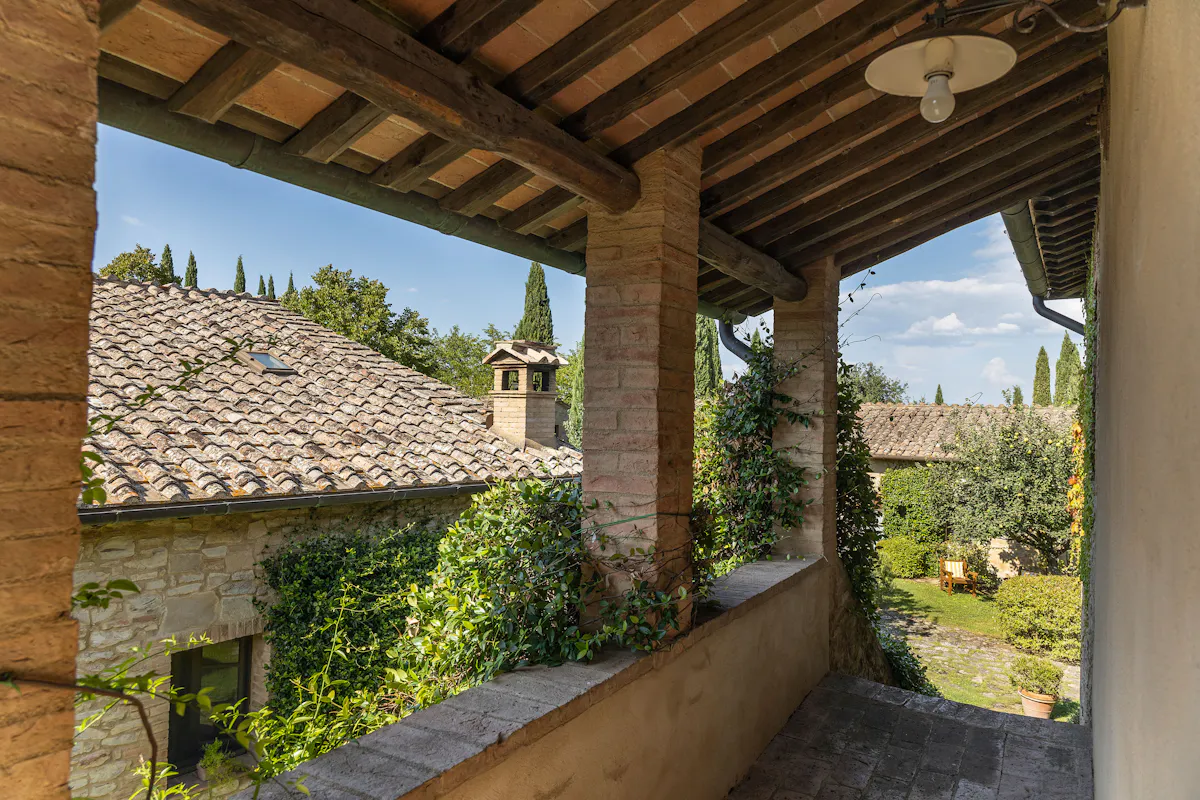 a view of a stone building that has a bench in a garden
