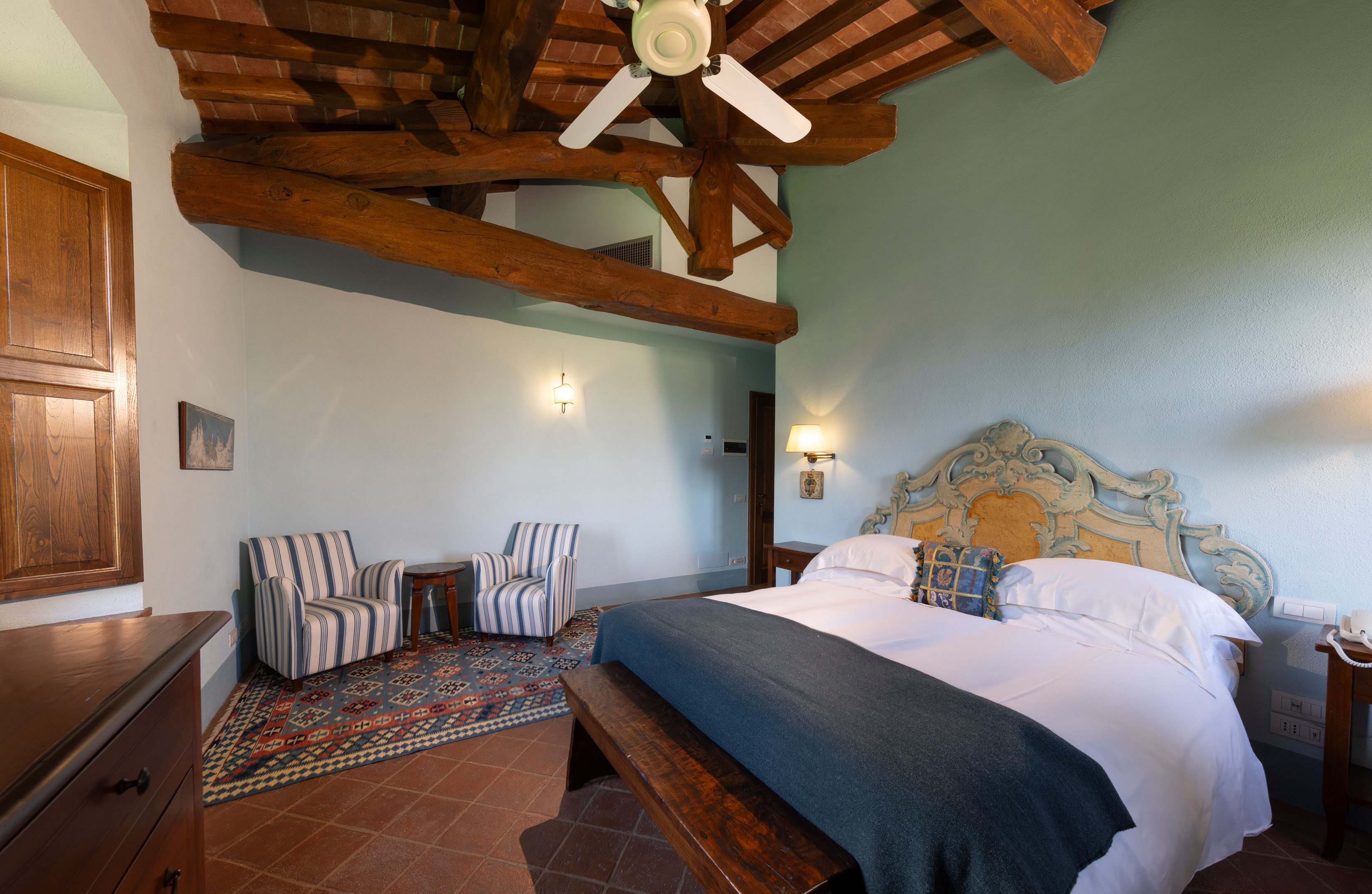 a bedroom with a bed and desk in a room