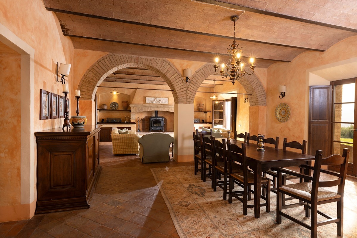 a kitchen with wooden cabinets and a dining room table