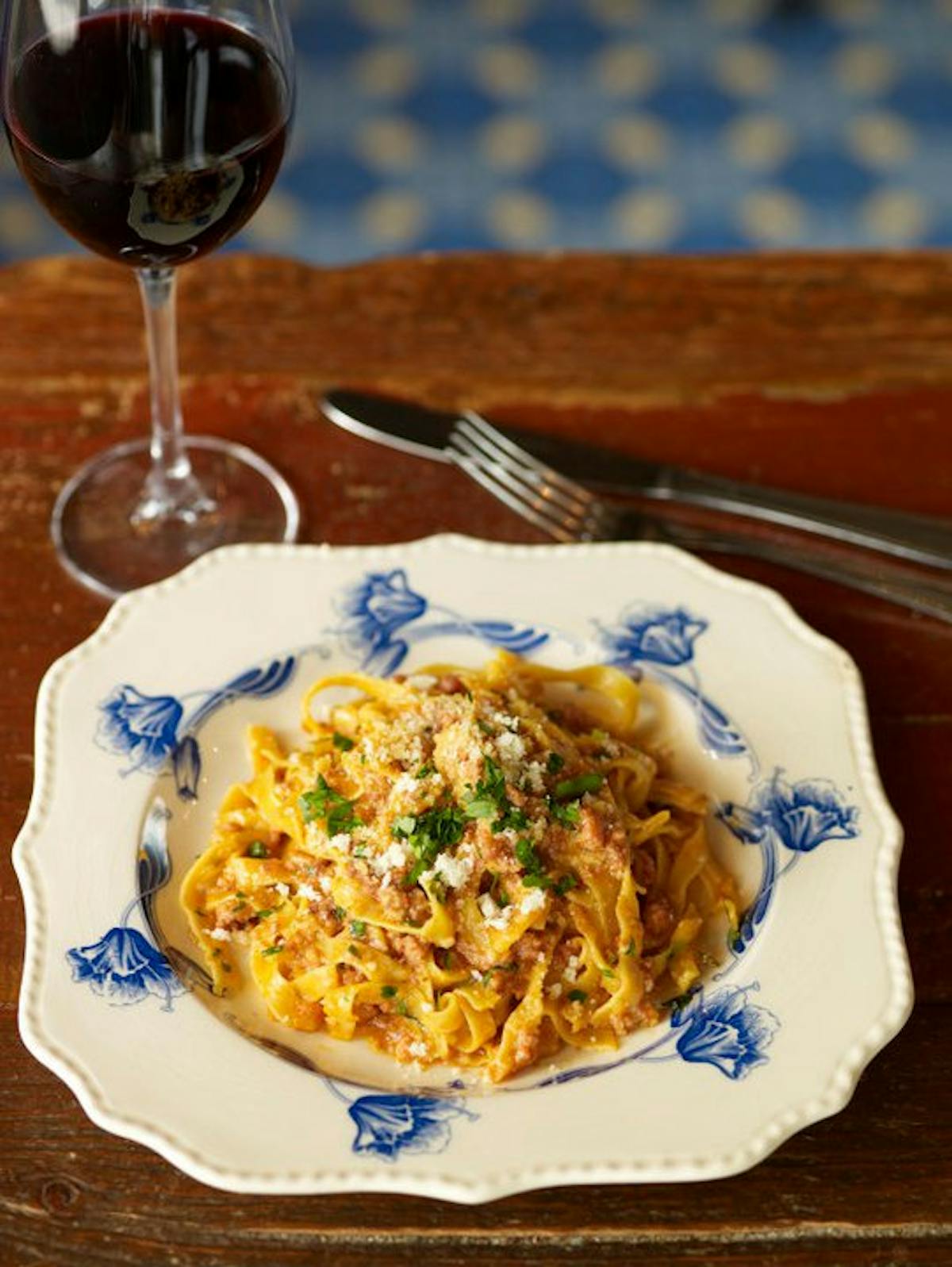 a plate of food and a glass of wine