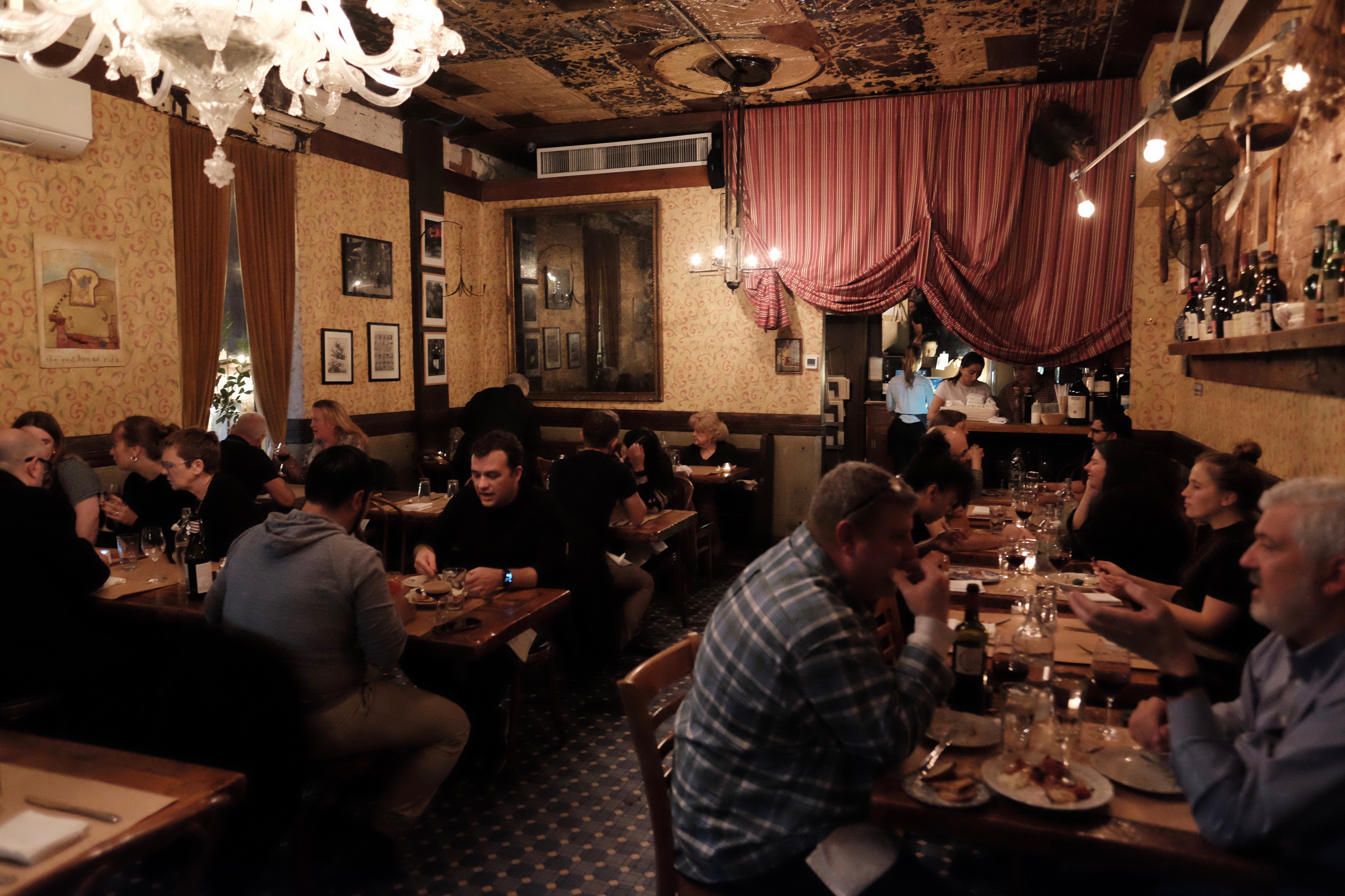 a group of people sitting at a table in a restaurant