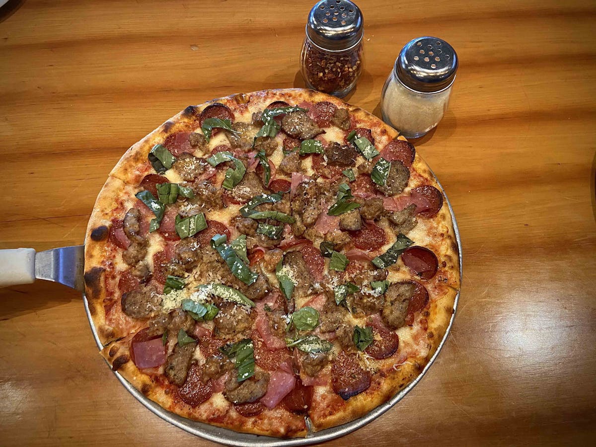 a pizza sitting on top of a wooden table