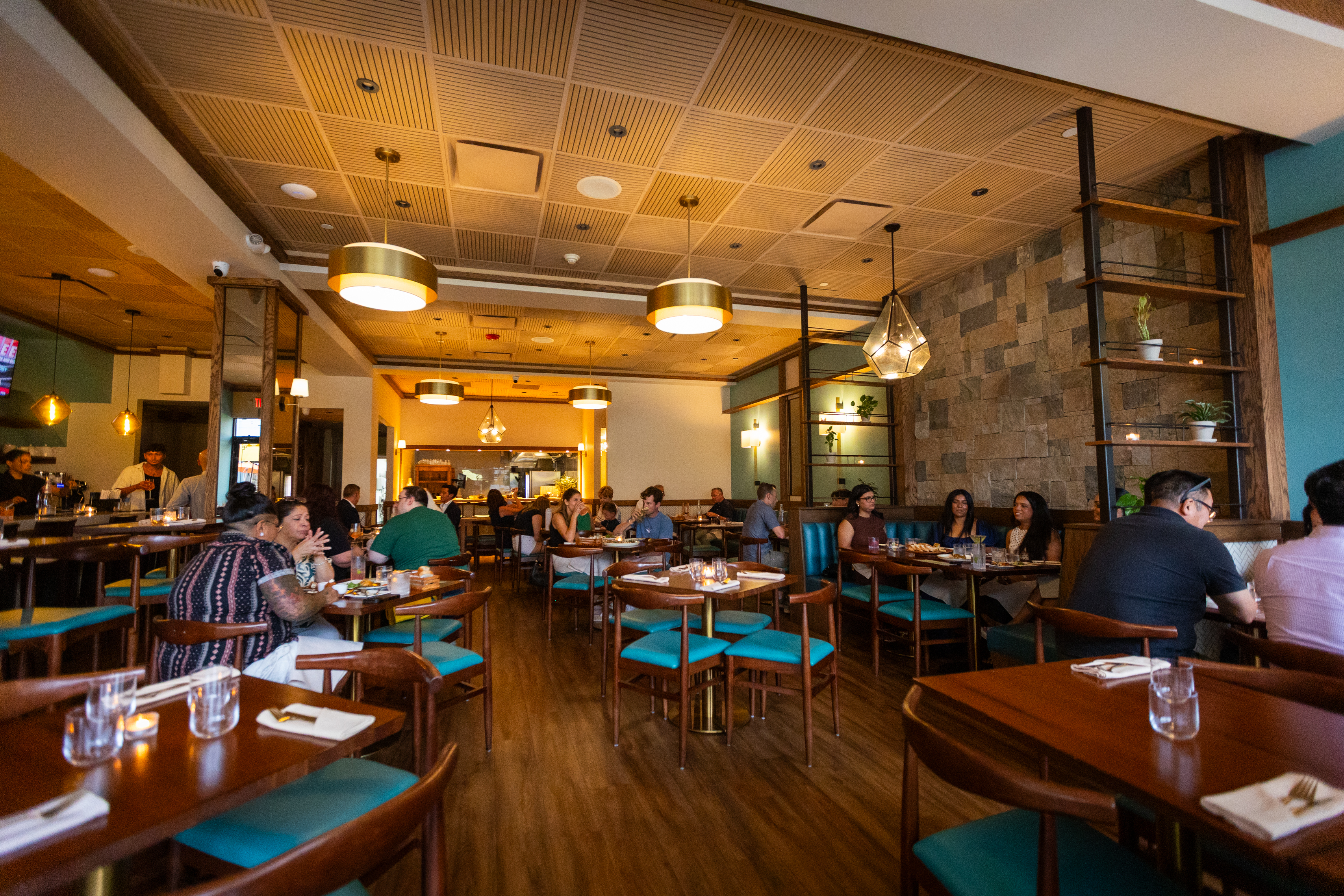 a group of people sitting at tables in a restaurant