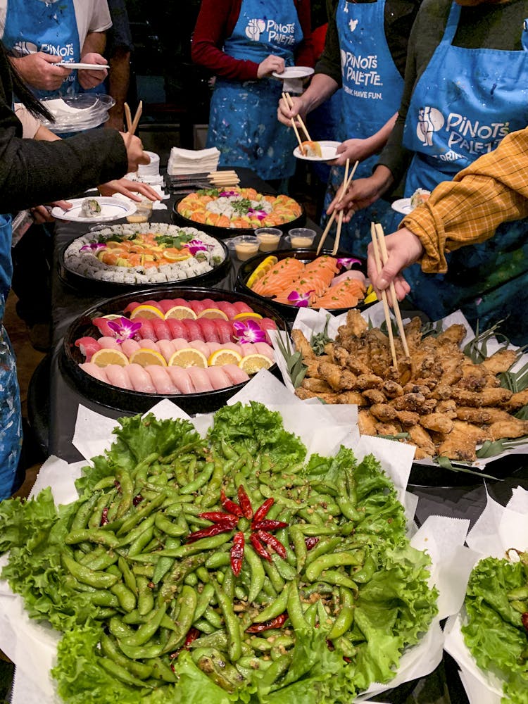 a group of people sitting at a table with food