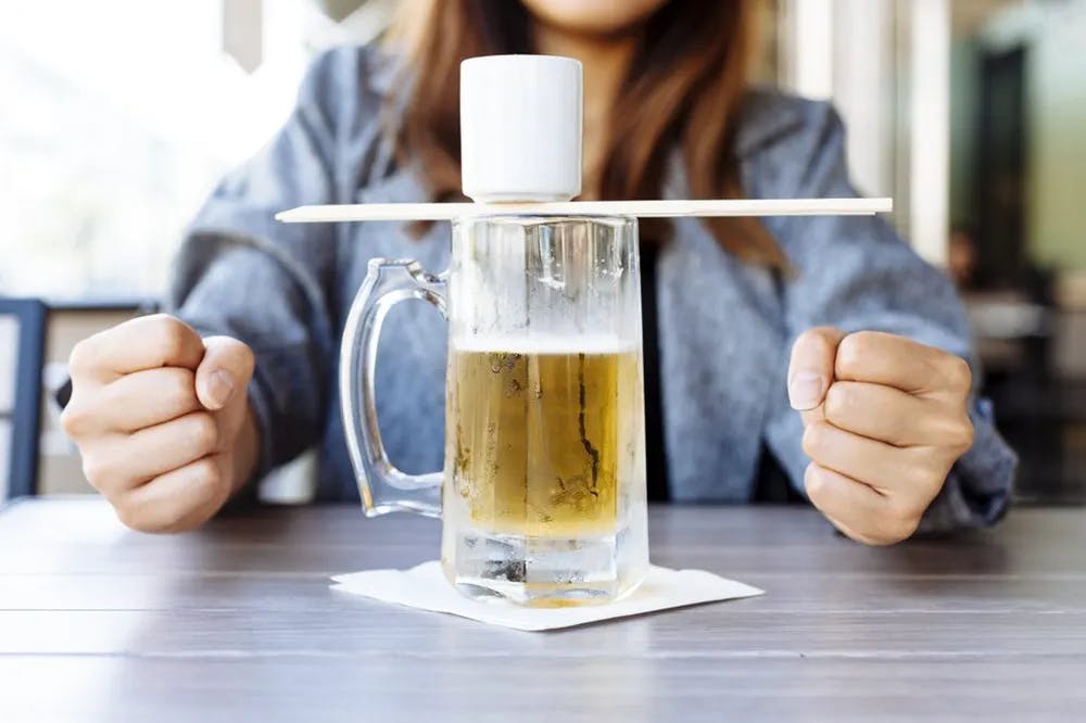 a person sitting at a table with a cup of coffee