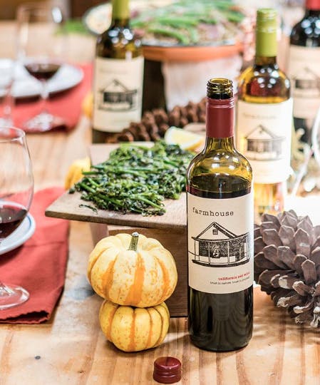 a bottle of wine sitting on top of a wooden cutting board