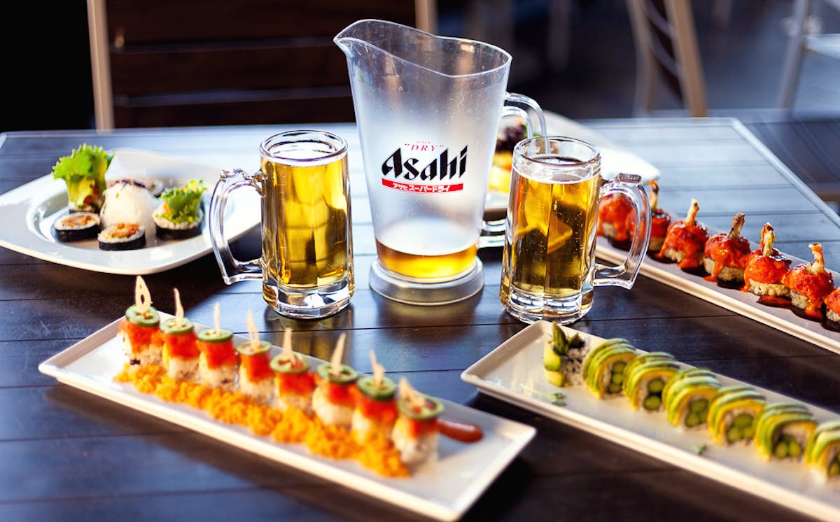 a plate of food and a glass of beer on a table