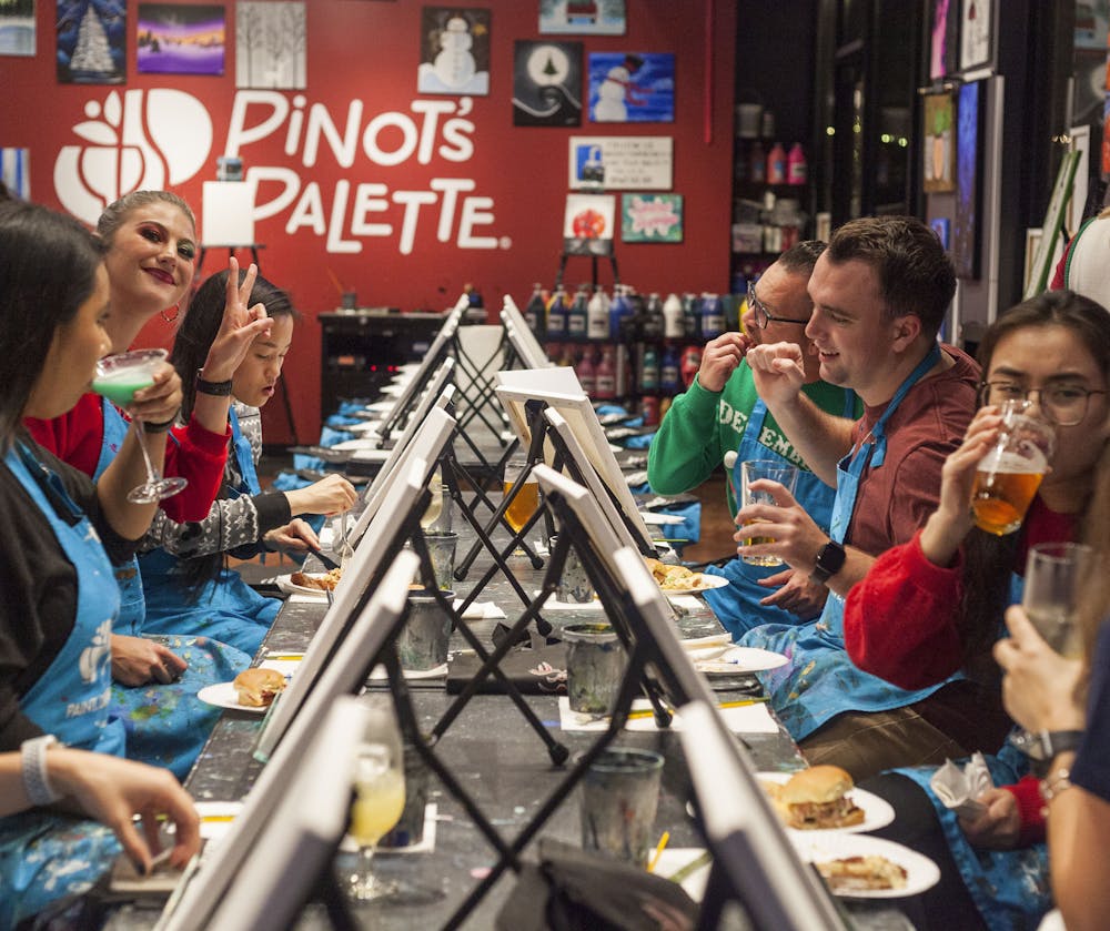 a group of people sitting at a table eating food