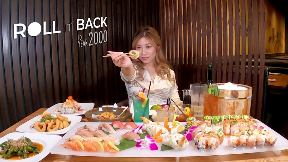 a woman sitting at a table with a plate of food