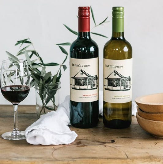 a bottle of wine and a glass of beer on a table