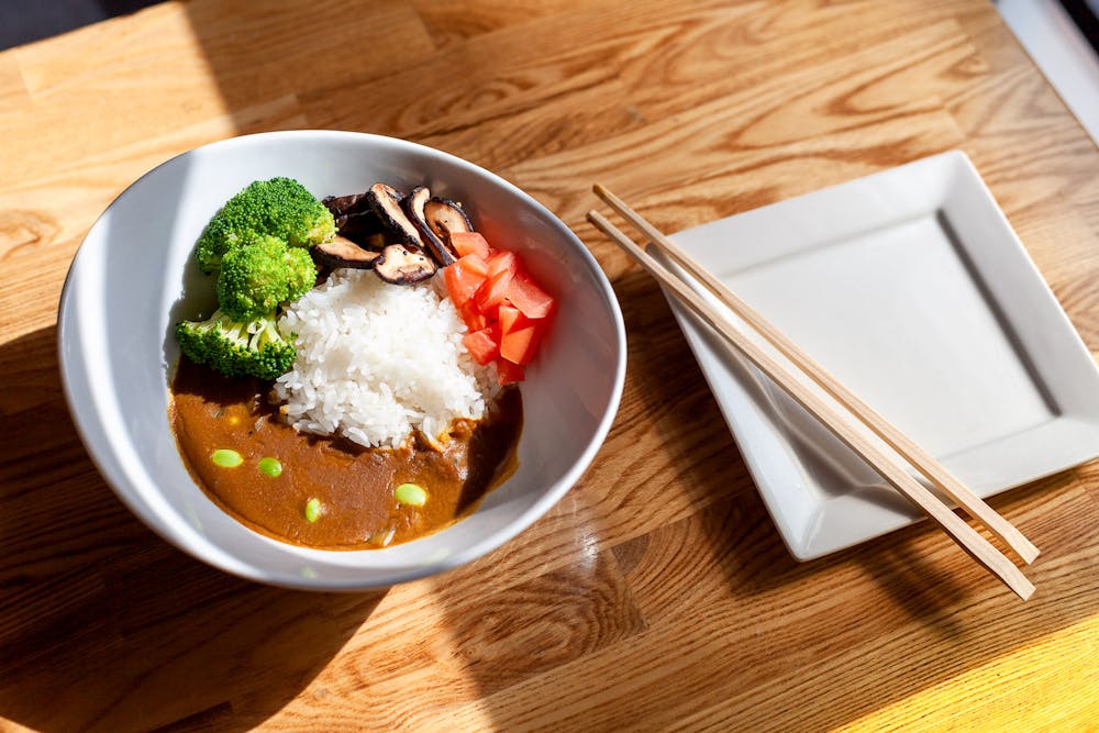 a plate of food sitting on top of a wooden table