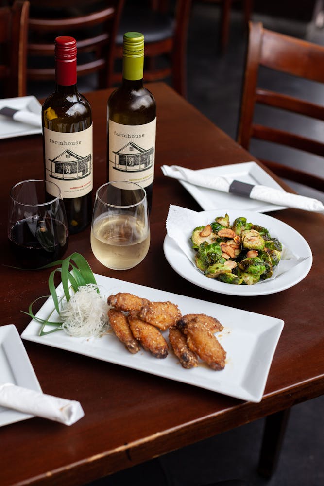 a plate of food and a bottle of wine on a table