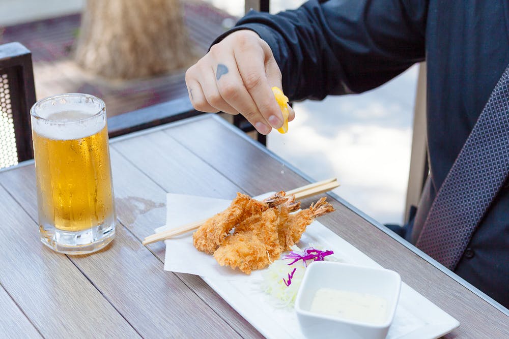 a person sitting at a table eating food