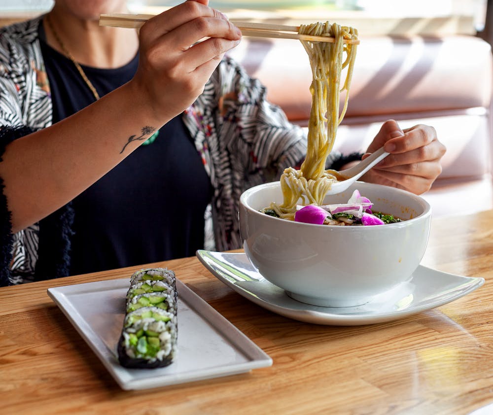 a woman sitting at a table eating food