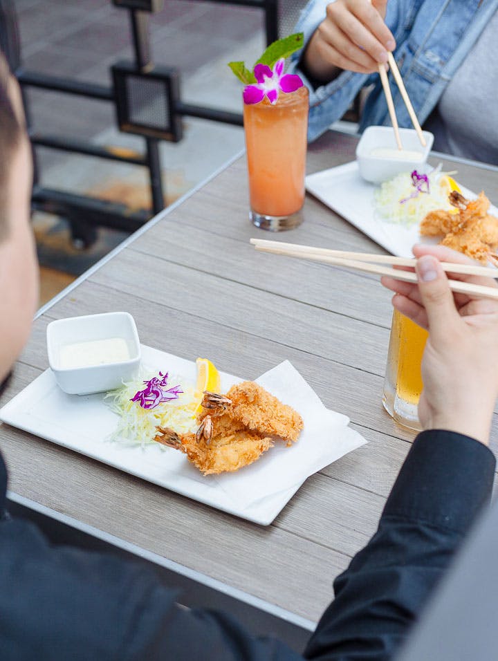 a woman sitting at a table eating food