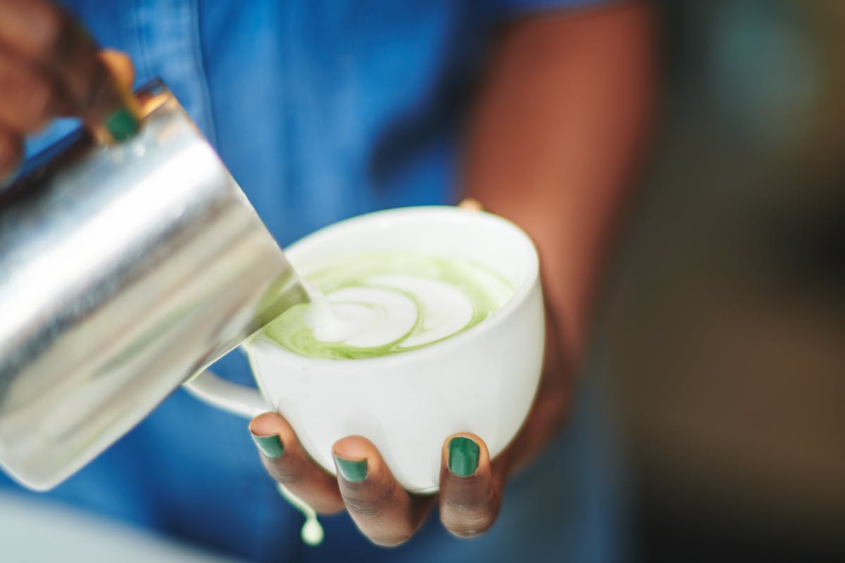 a close up of a person holding a cup