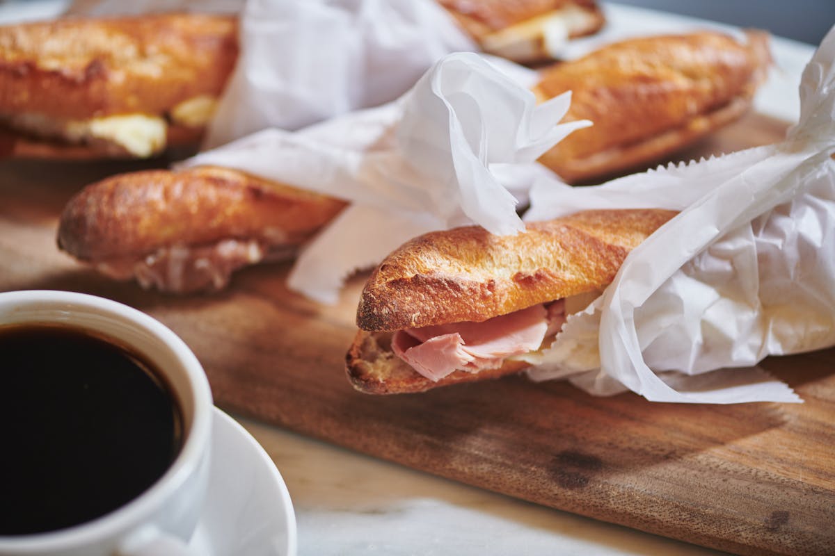 a close up of food on a table next to a cup of coffee