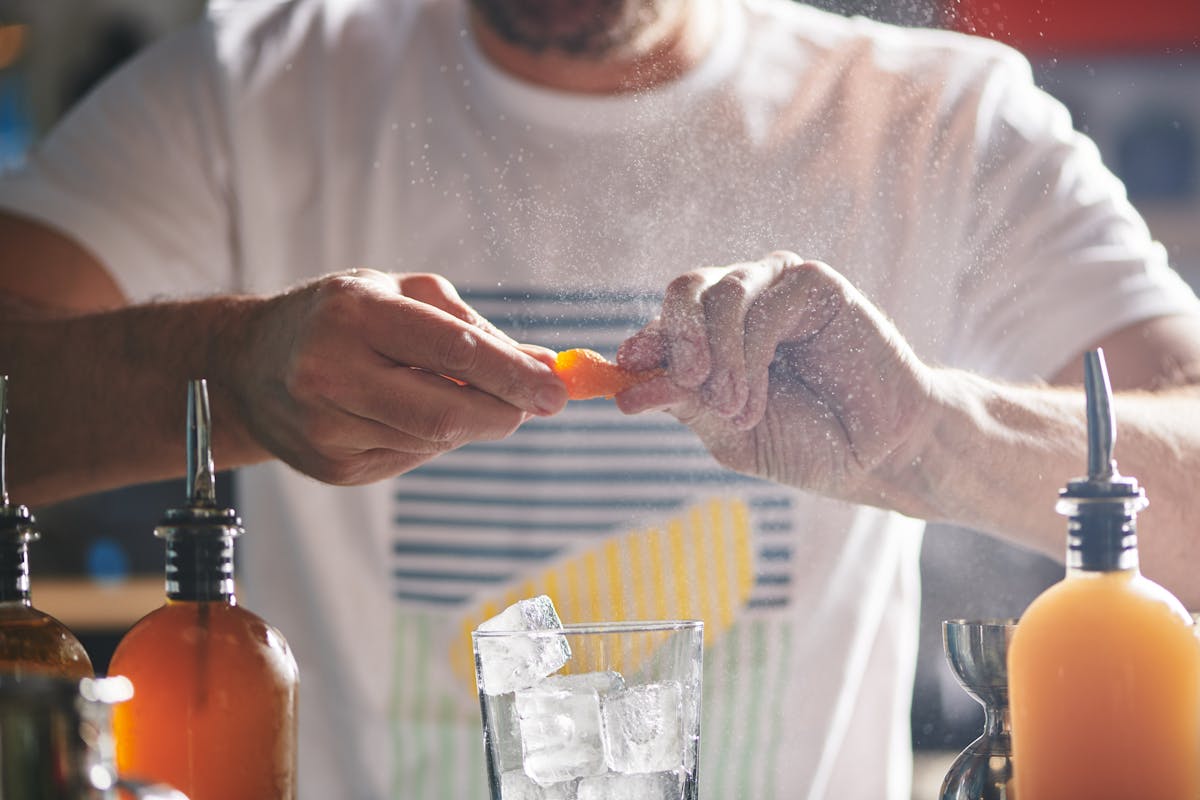 a man holding a glass of orange juice