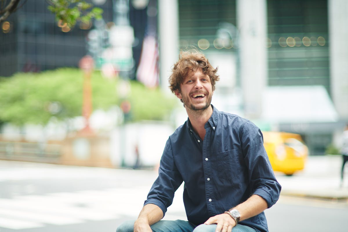 a man sitting on a sidewalk