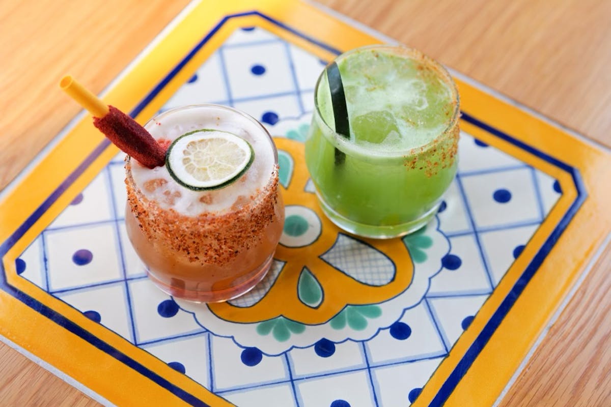 a cup of coffee sitting on top of a wooden table
