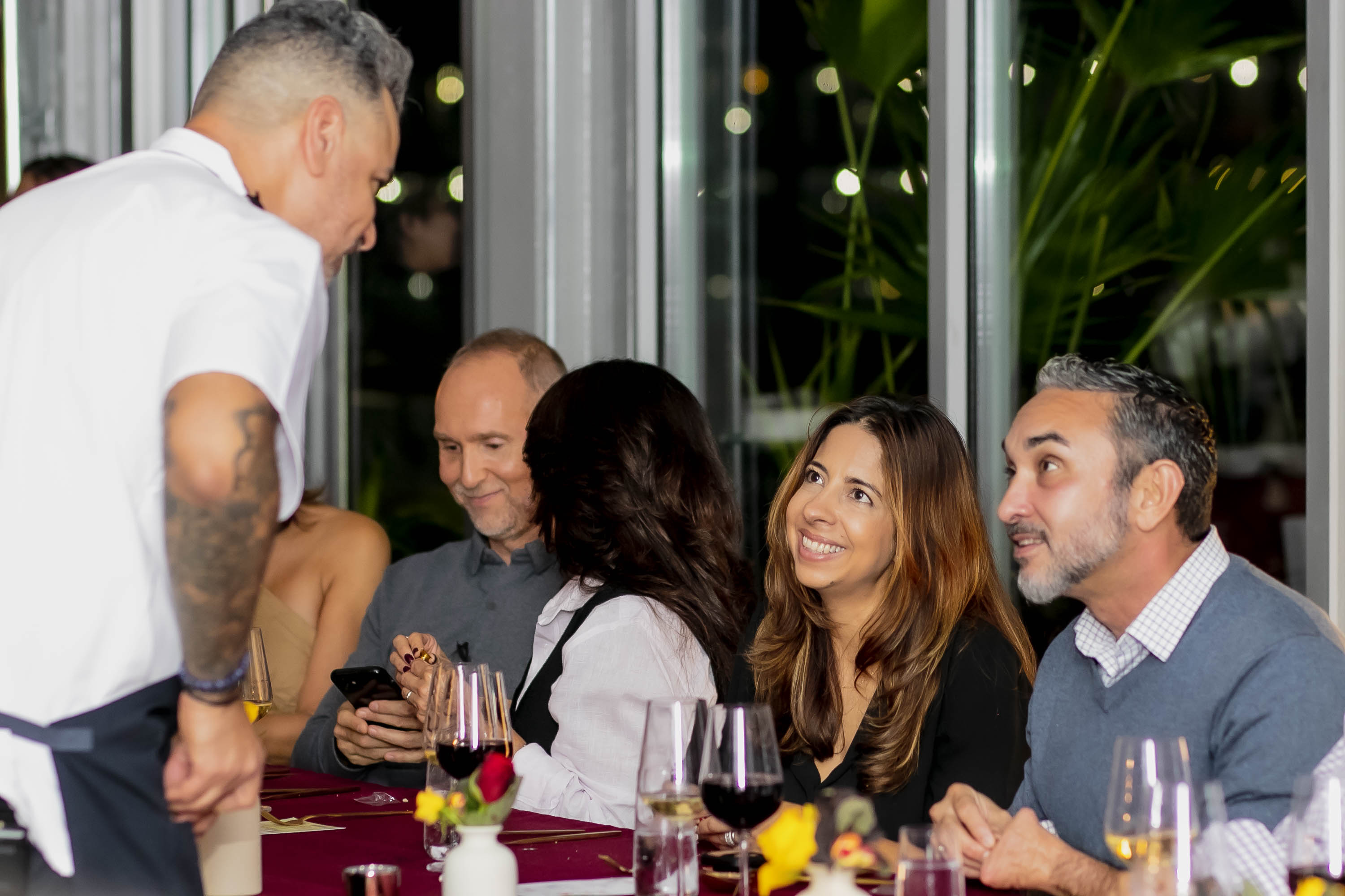 a group of people sitting at a table with wine glasses
