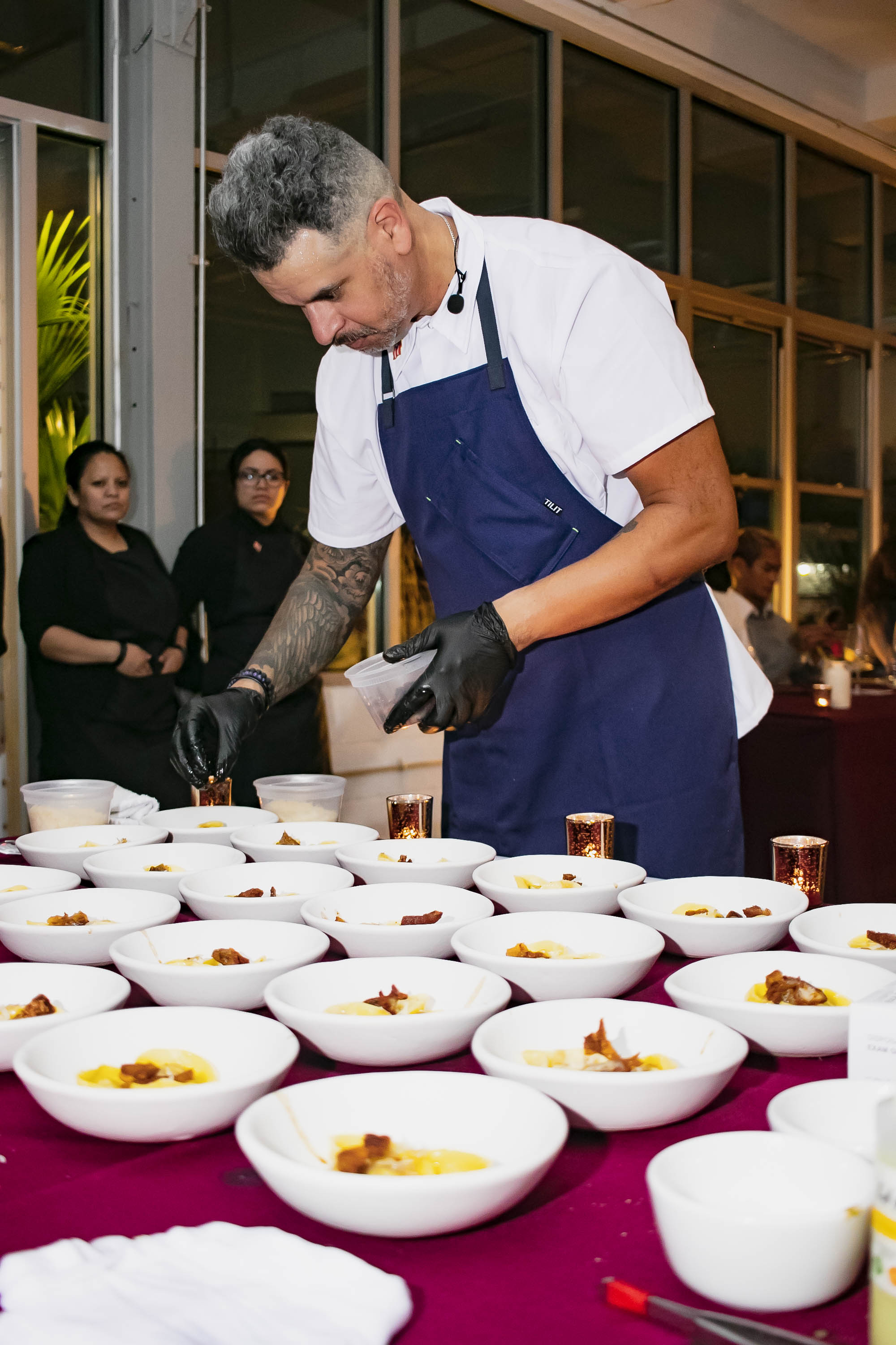 a group of people around a table with a plate of food