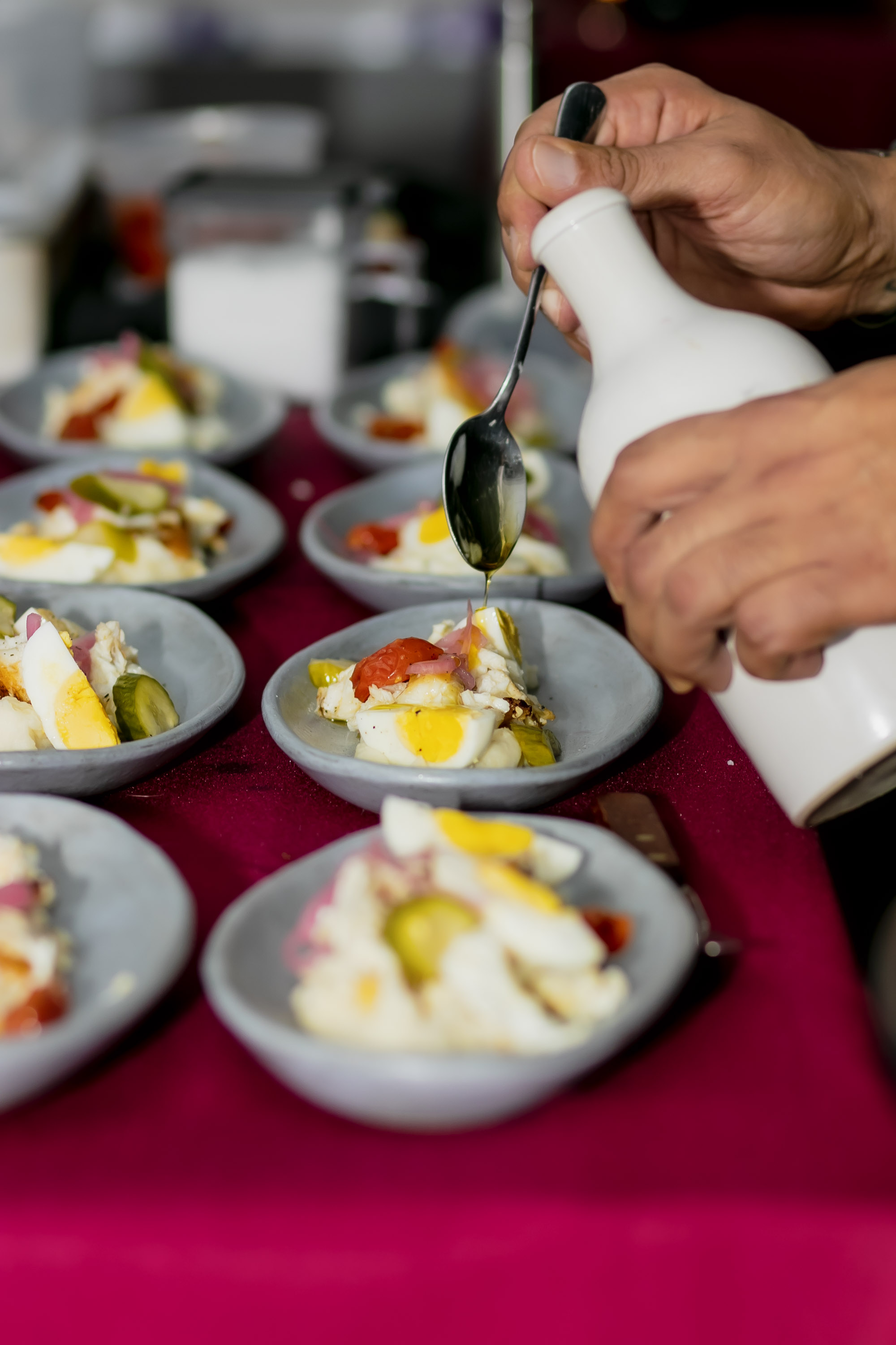 a close up of a person holding a plate of food on a table