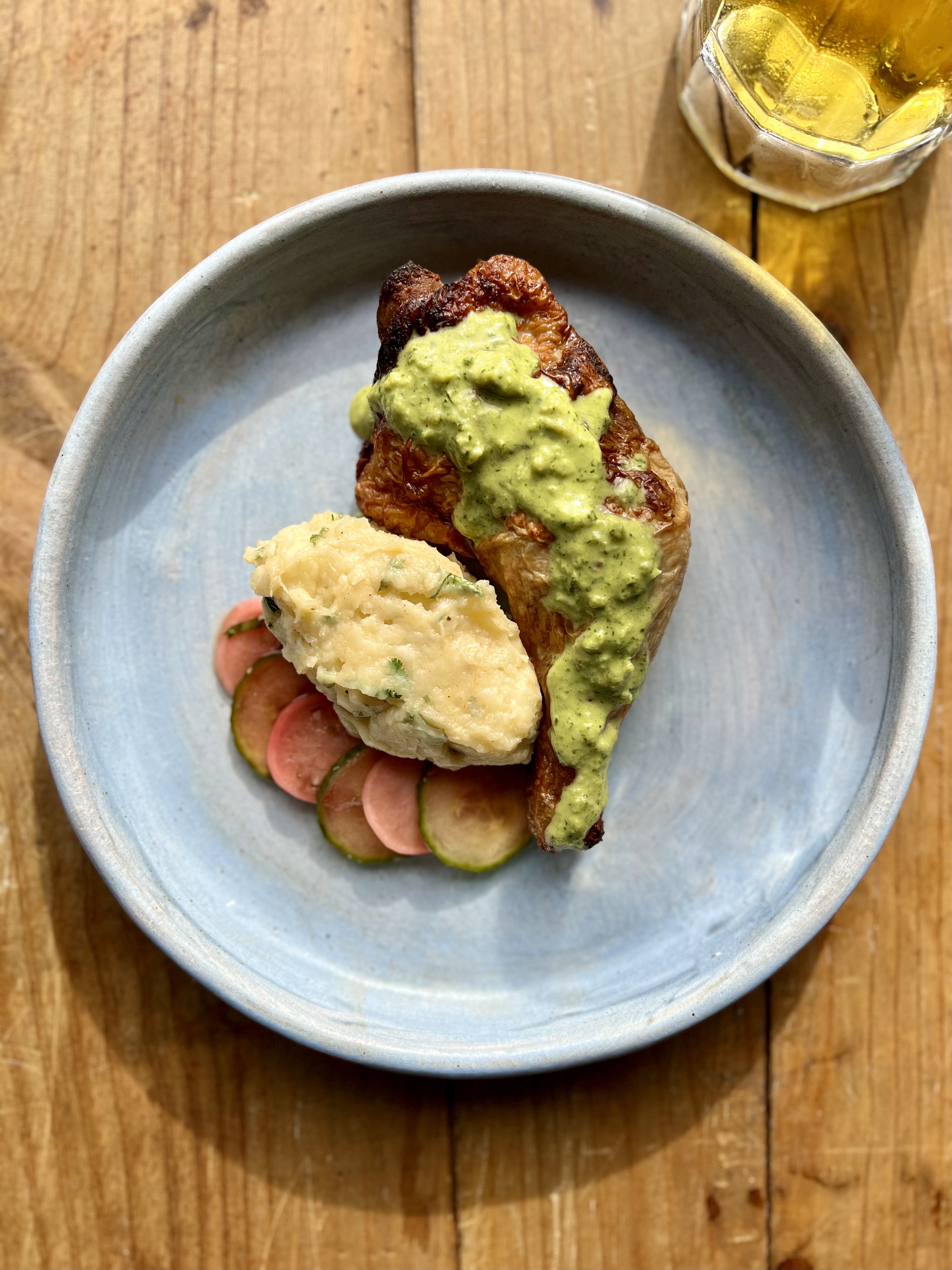 a plate of food sitting on top of a wooden table
