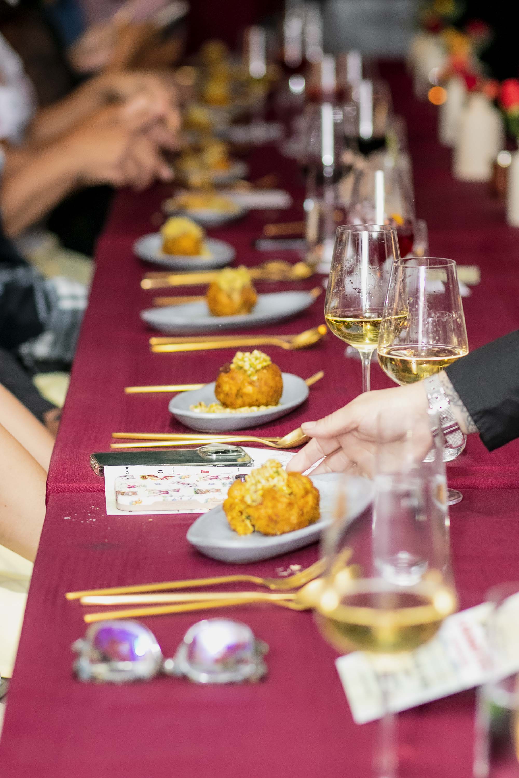 a group of people sitting at a table with a plate of food