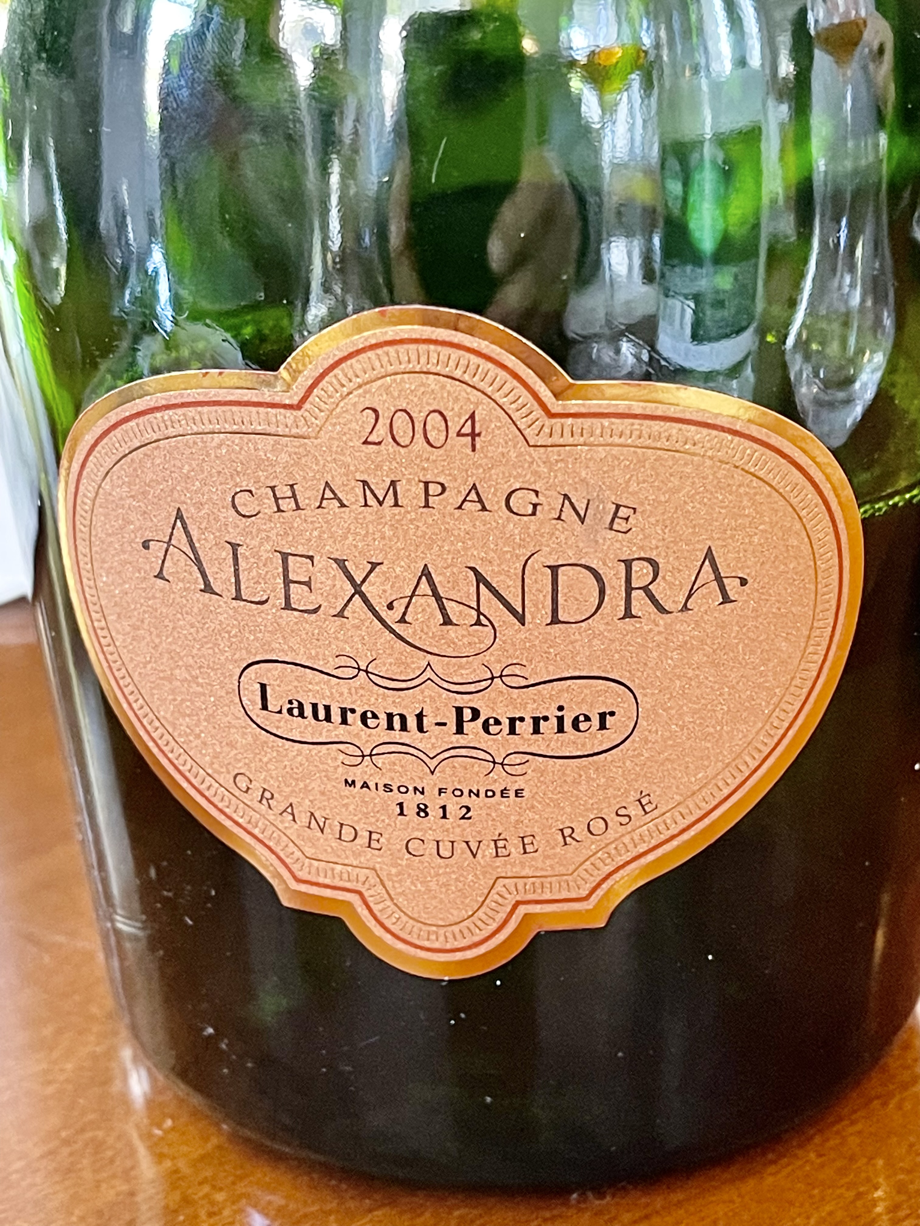 a close up of a bottle and a glass of wine