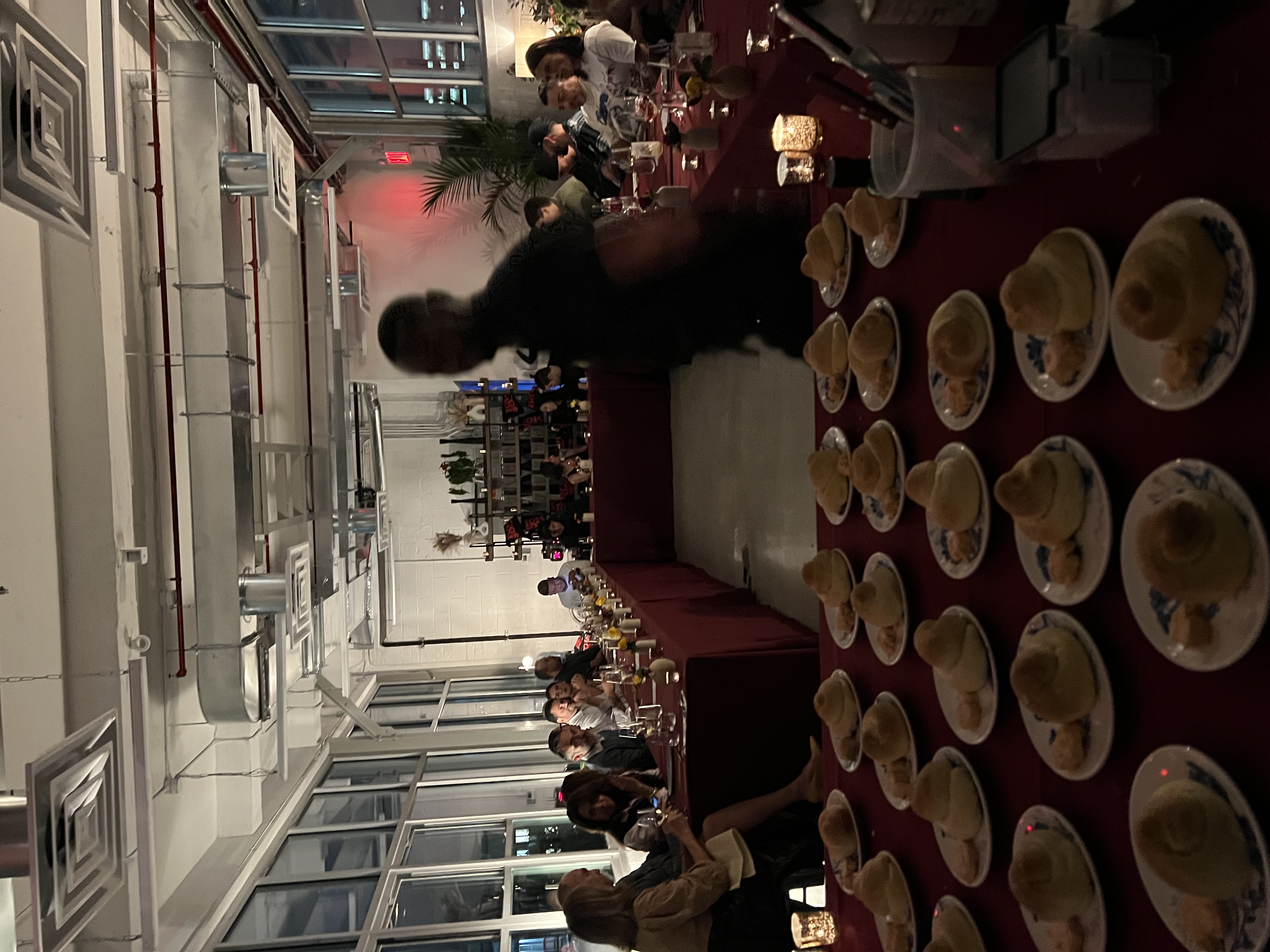a group of people sitting at a table in a restaurant
