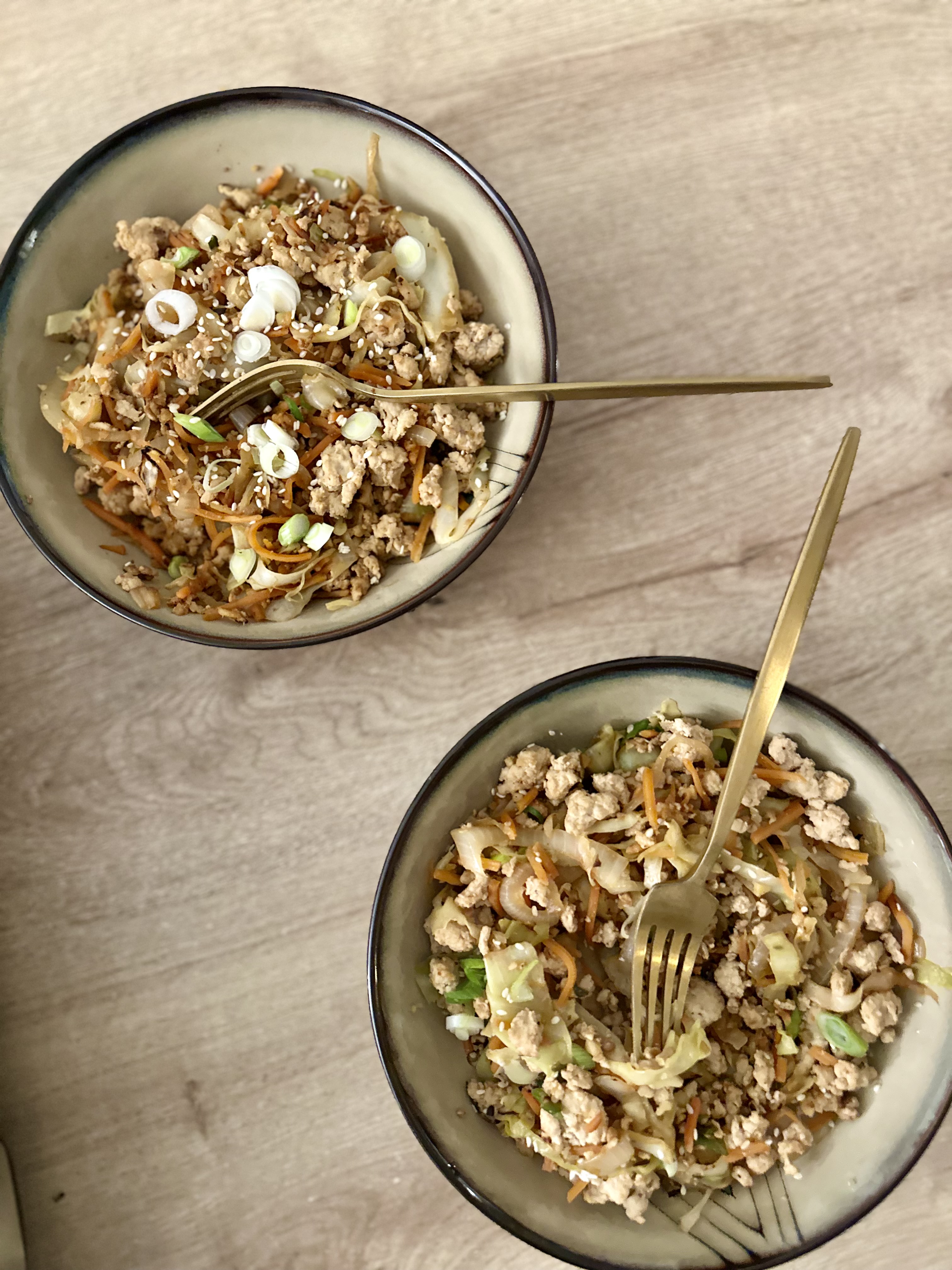 a bowl of food sitting on top of a wooden table