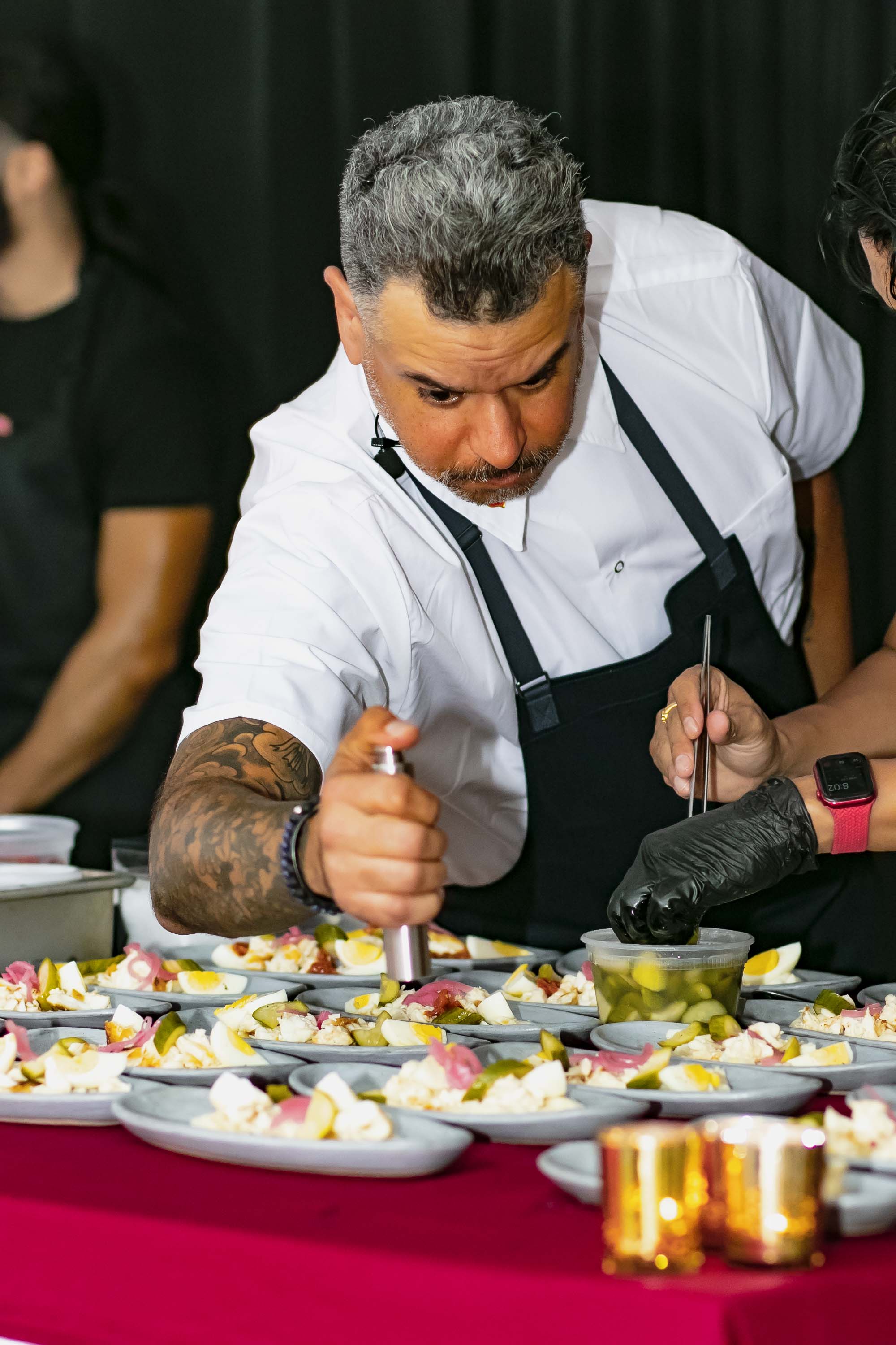 a person sitting at a table with a plate of food