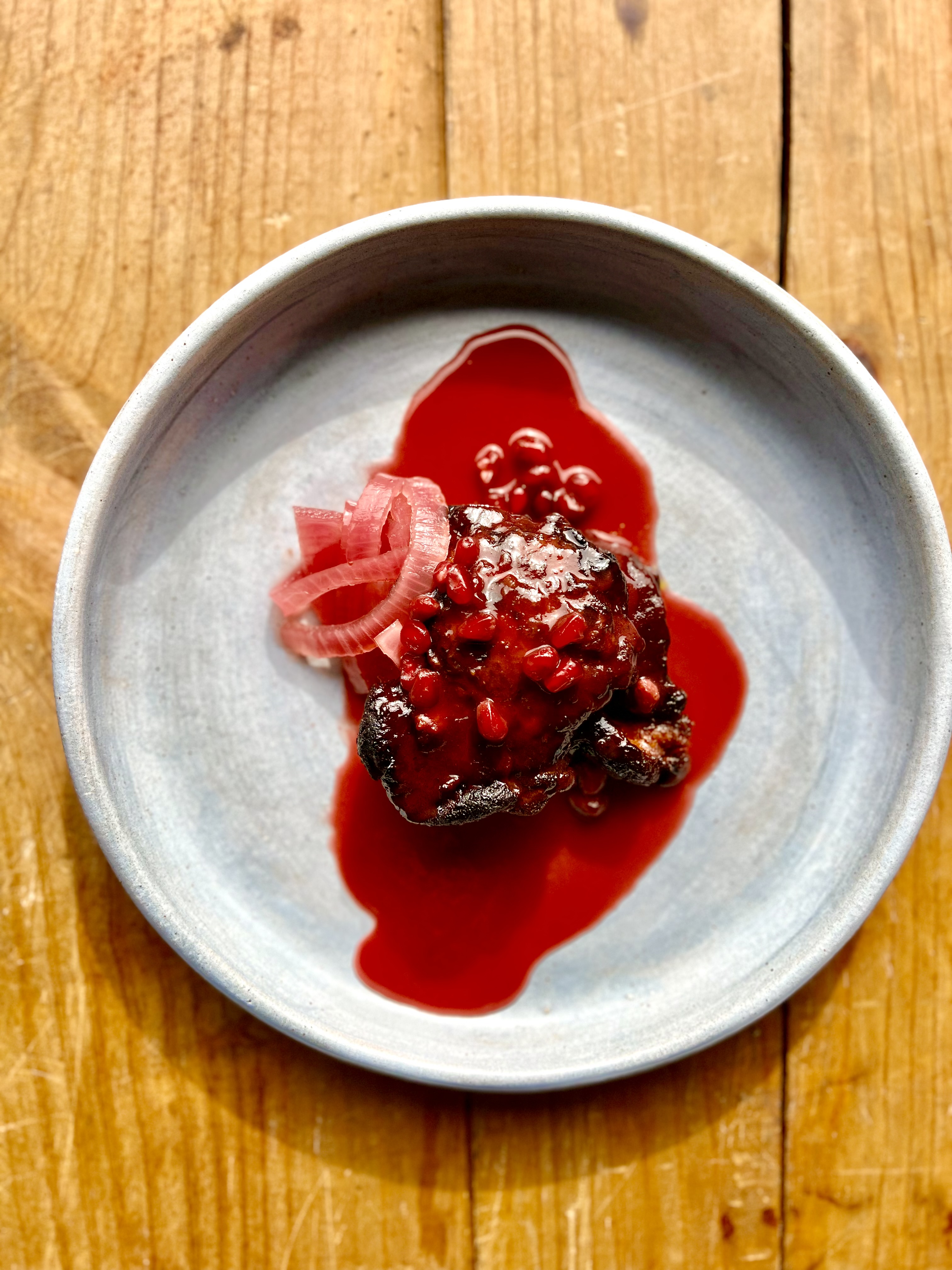 a plate of food sitting on top of a wooden table