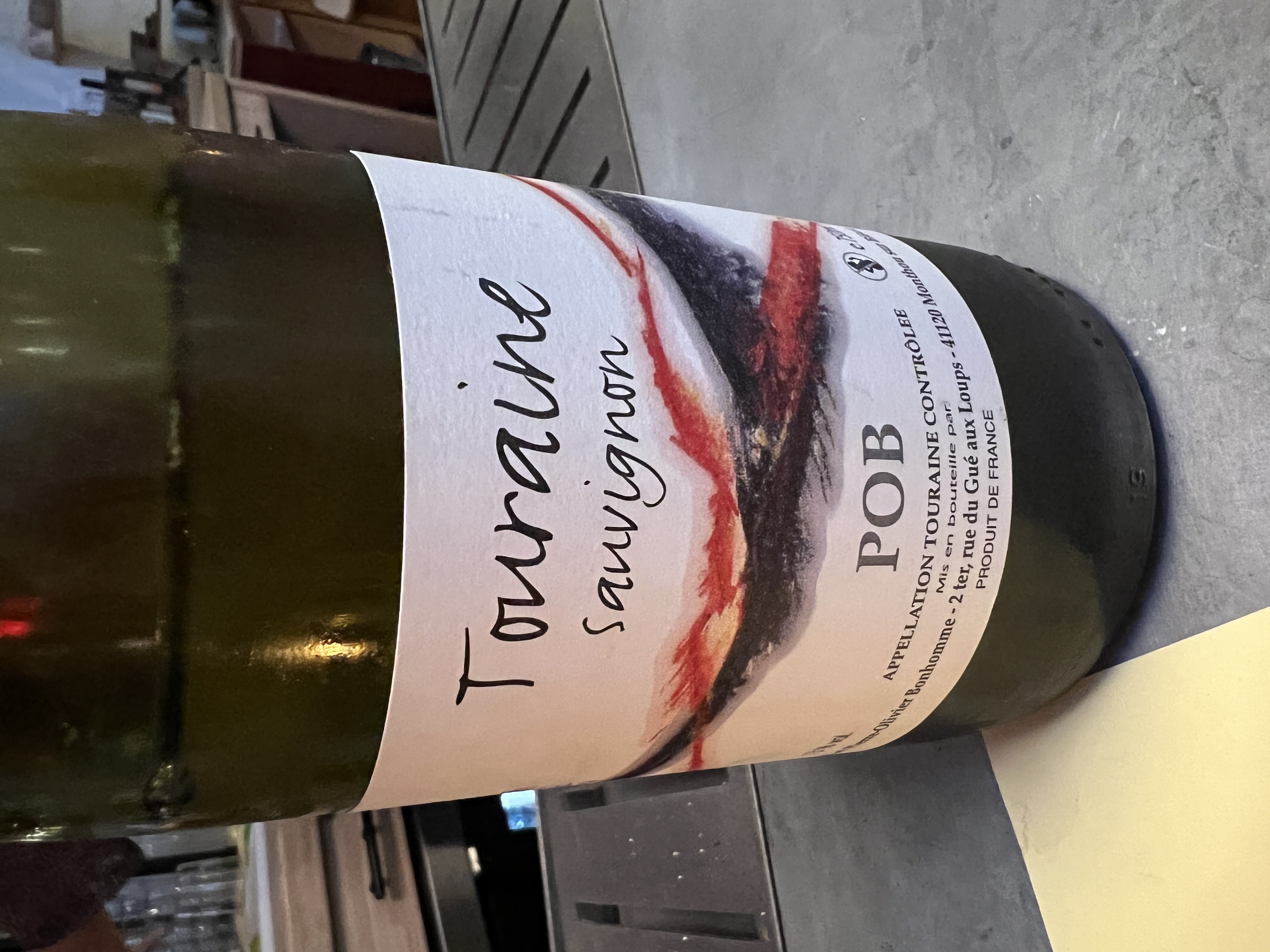 a bottle of wine and a glass of beer on a table