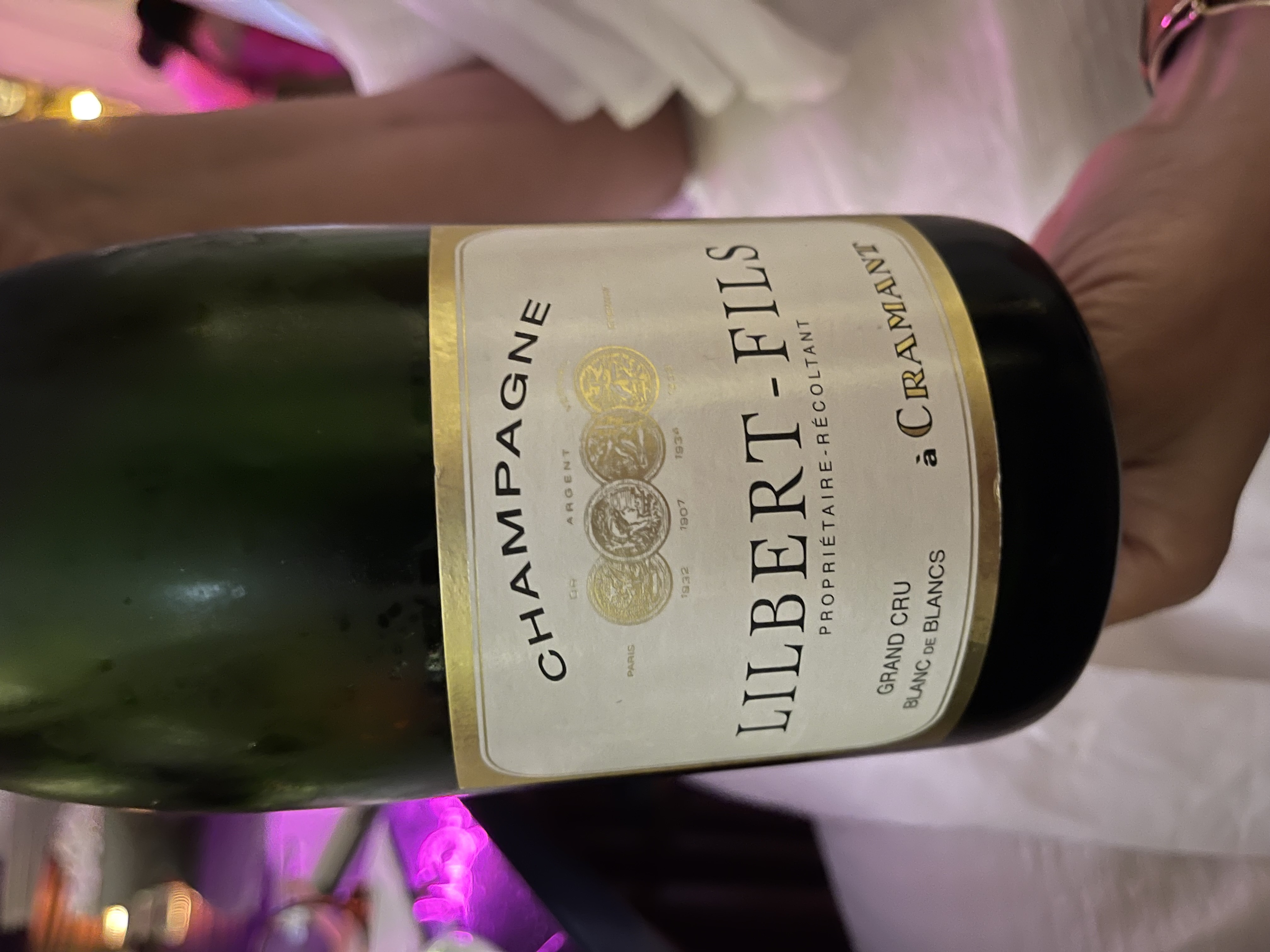 a close up of a bottle and a glass of wine