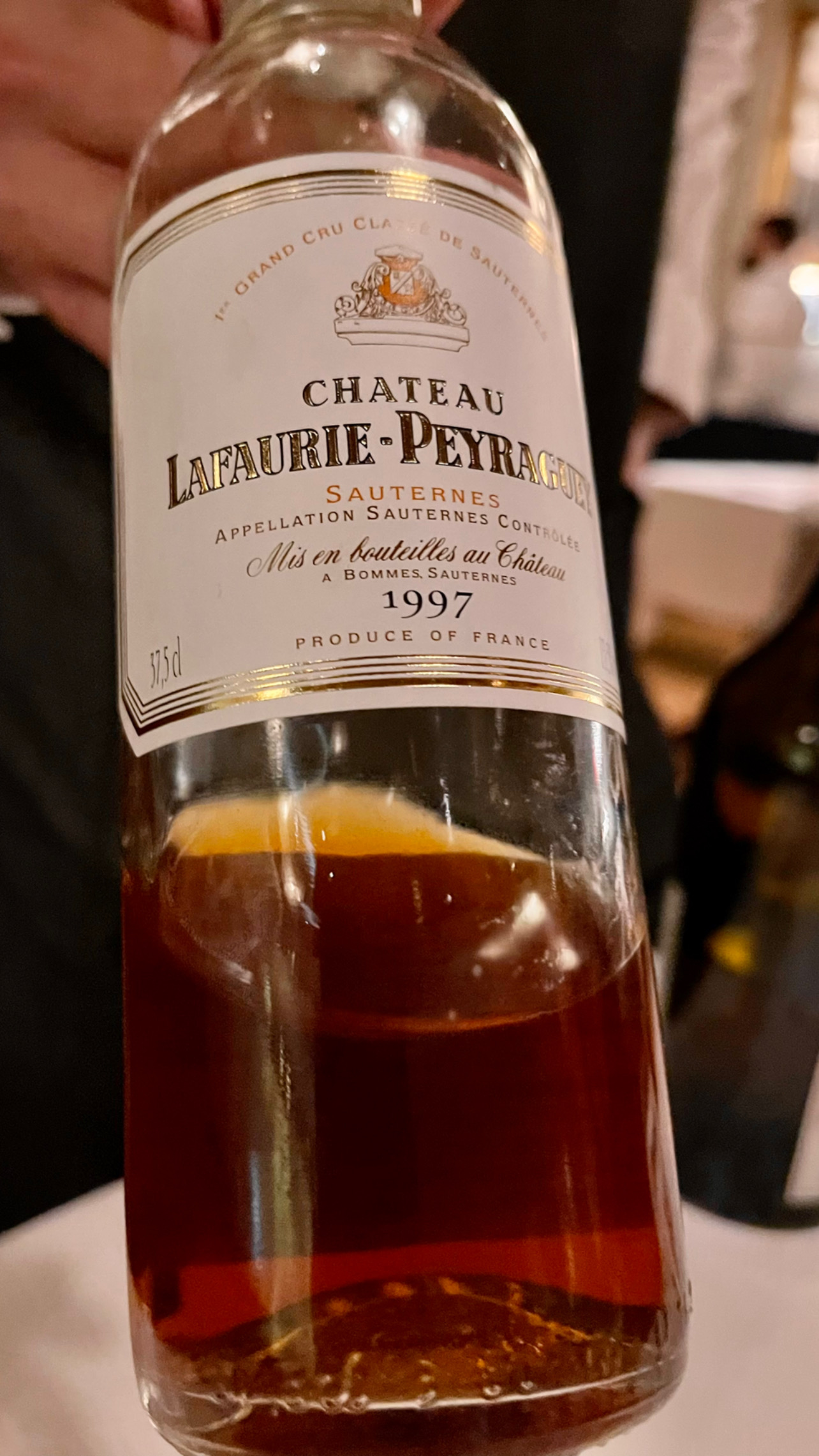 a close up of a bottle and a glass of wine