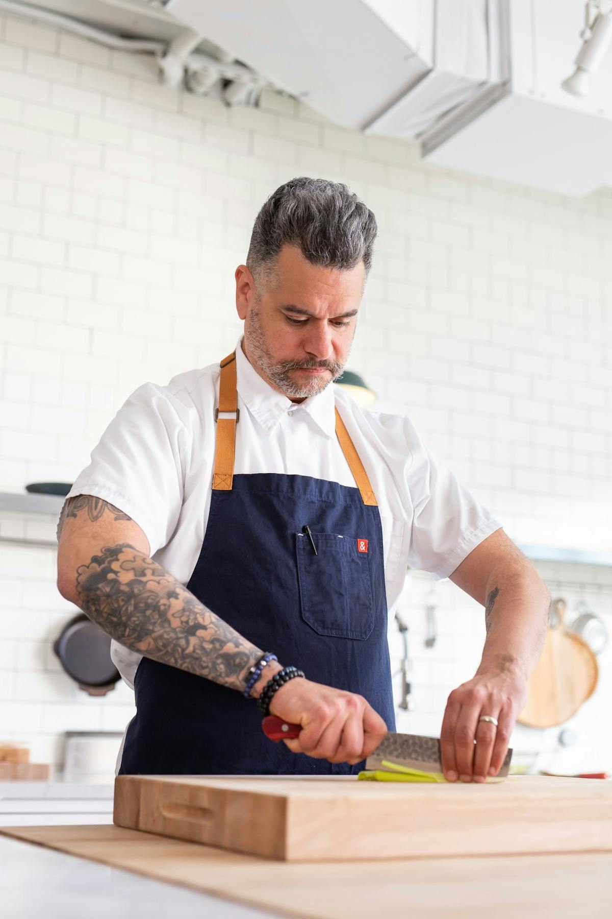 a man standing on top of a cutting board