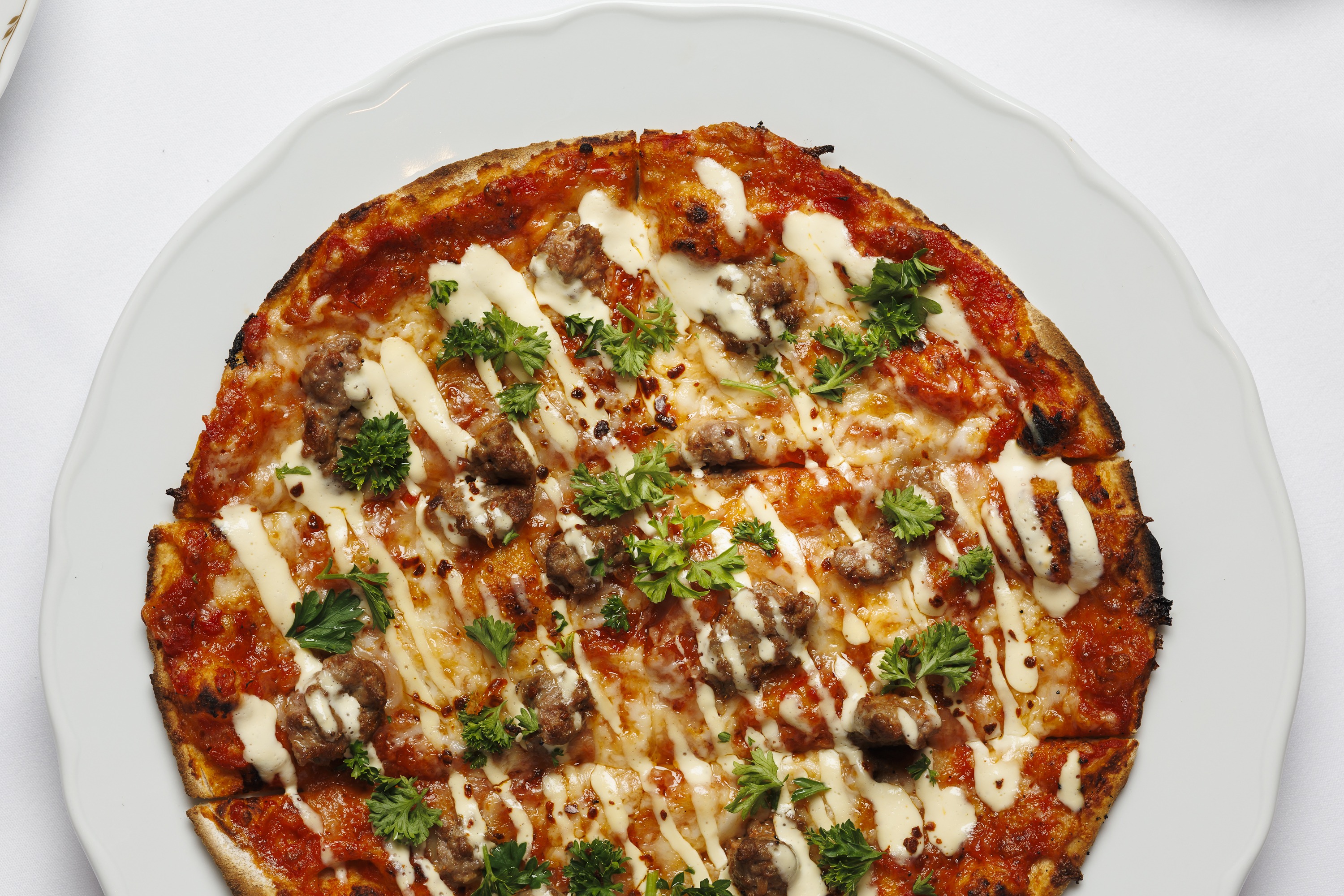 Spicy Lamb Pizza: lamb sausage, spicy tomato, mozzarella, smoked goat cheese, garlicky yogurt