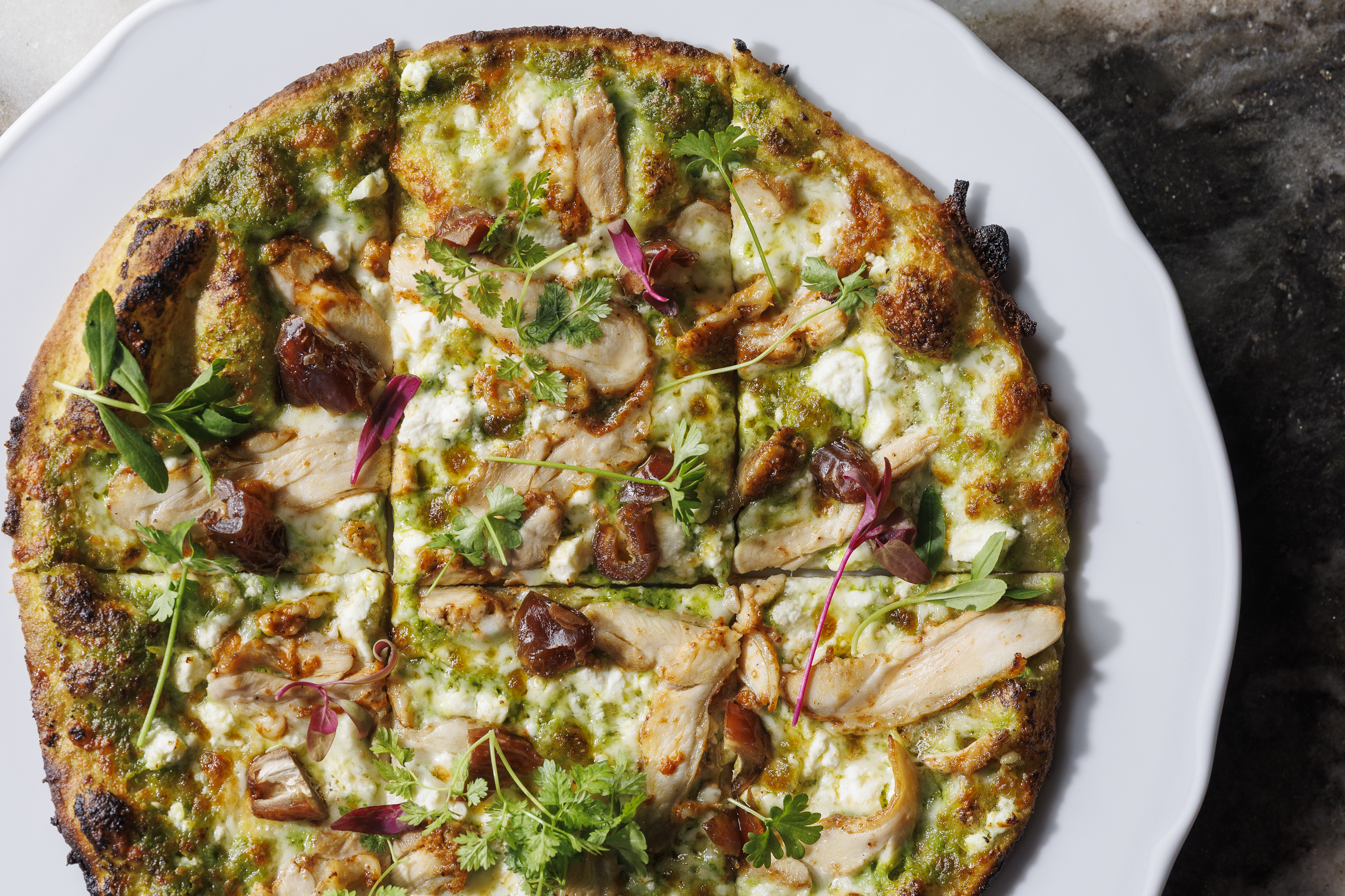 Mediterranean Chicken  lemon chicken, green tahini, feta, mozzarella, dates, calabrian hot honey