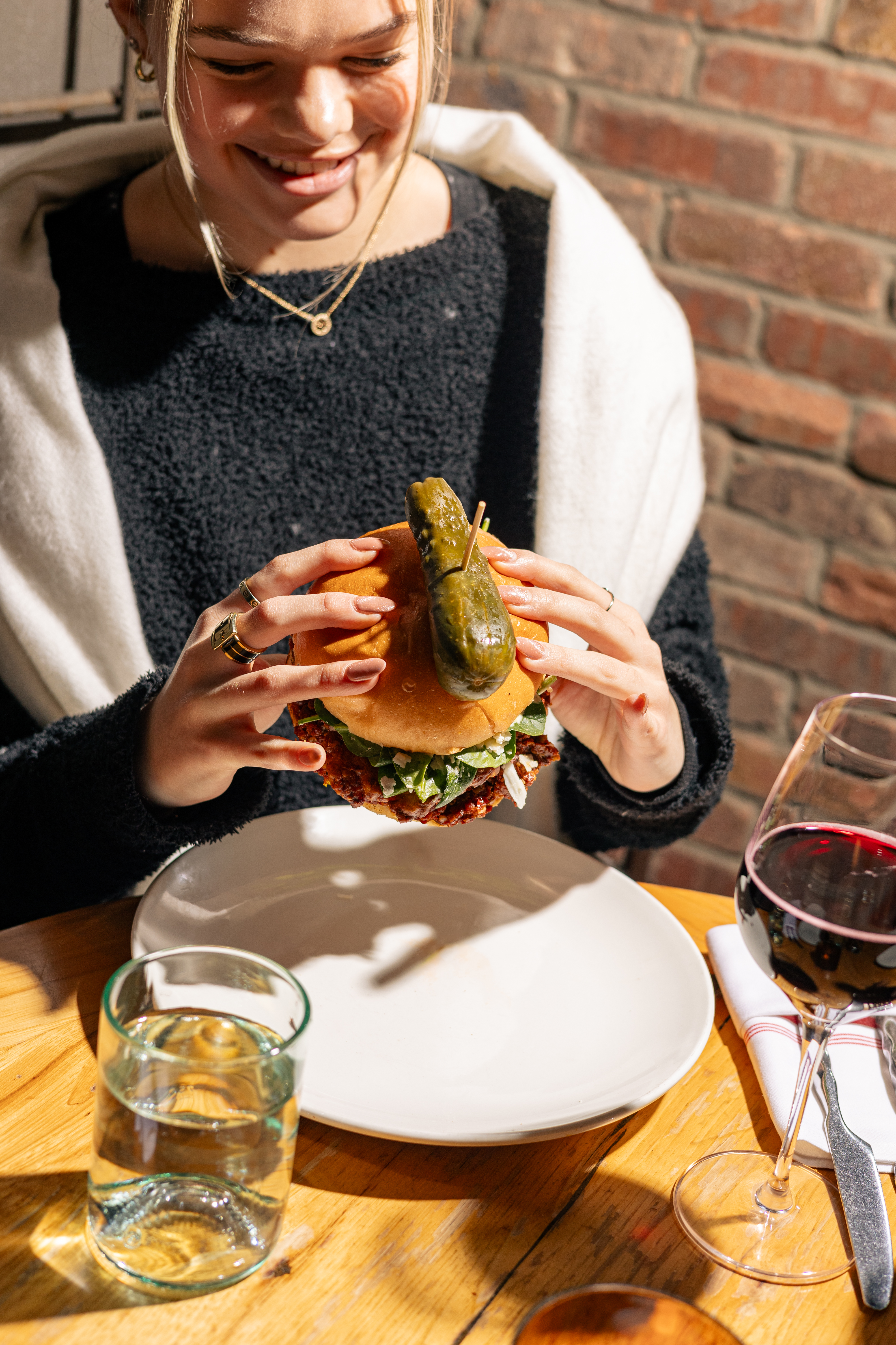 a woman sitting at a table eating food