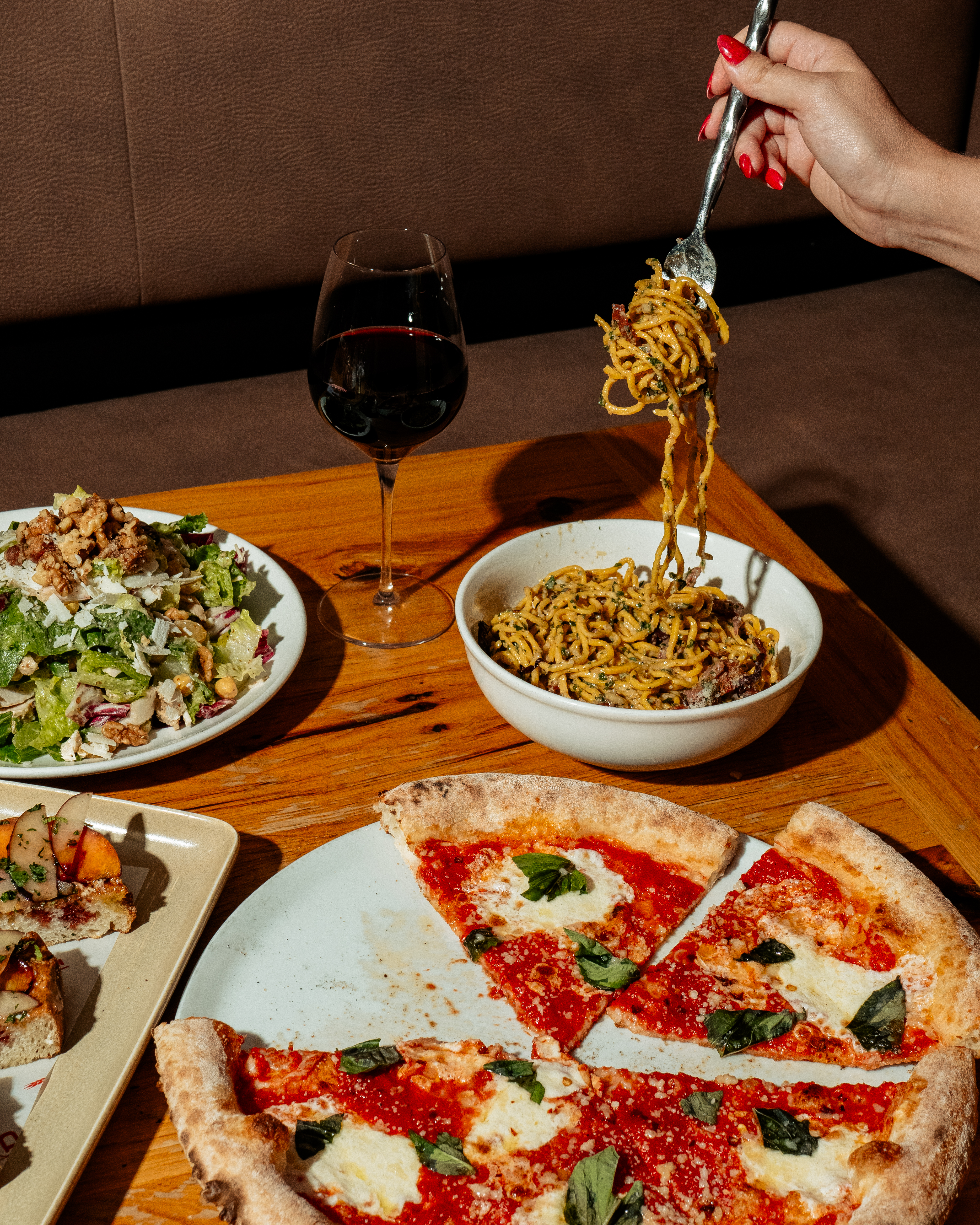a pizza sitting on top of a plate of food on a table