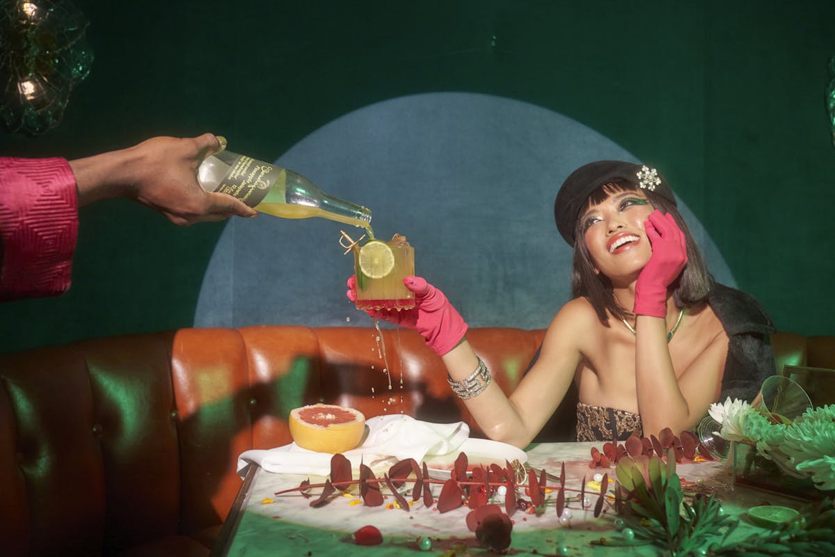 a woman sitting at a table with a birthday cake