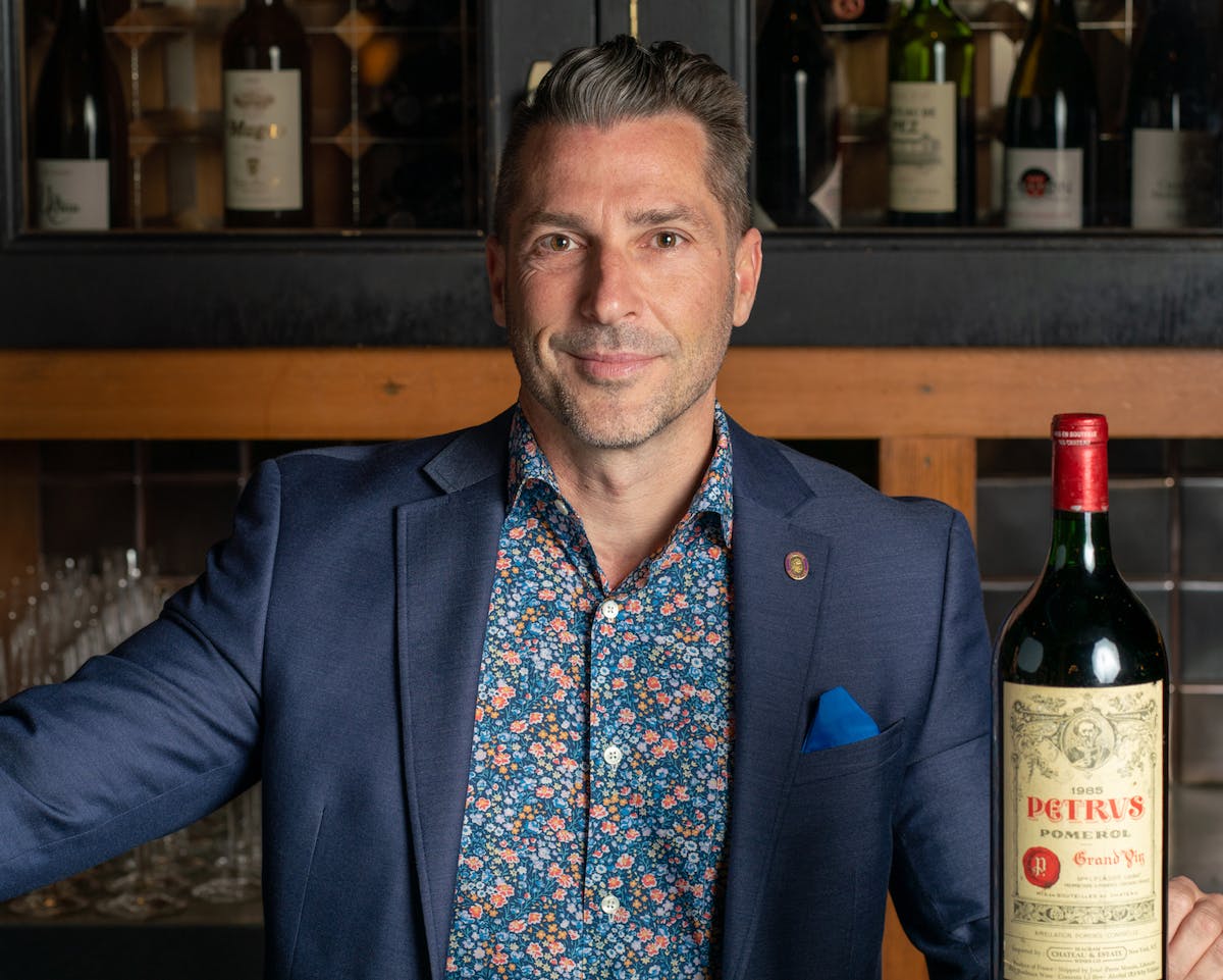 a man holding a bottle of wine