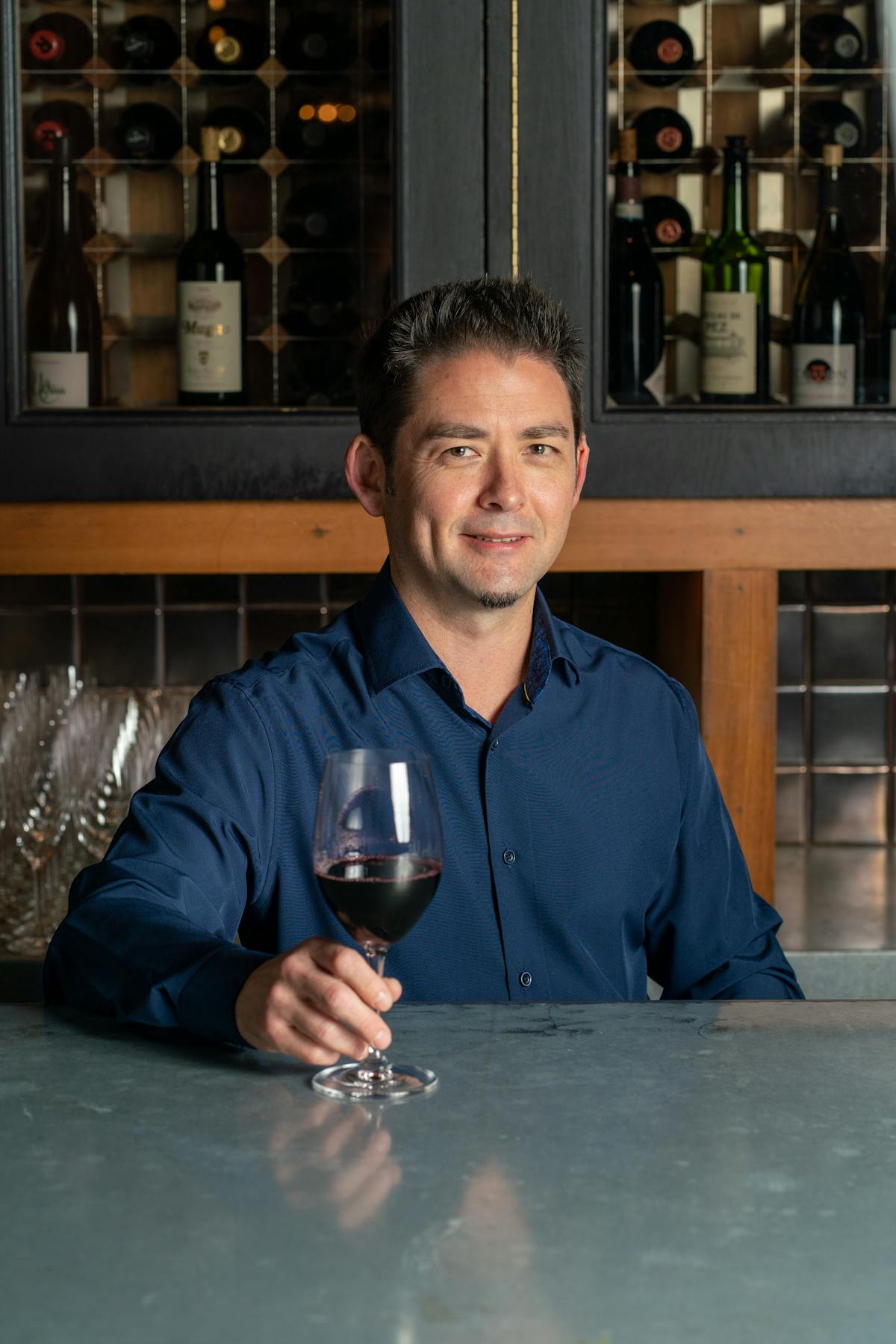a man holding a glass of wine